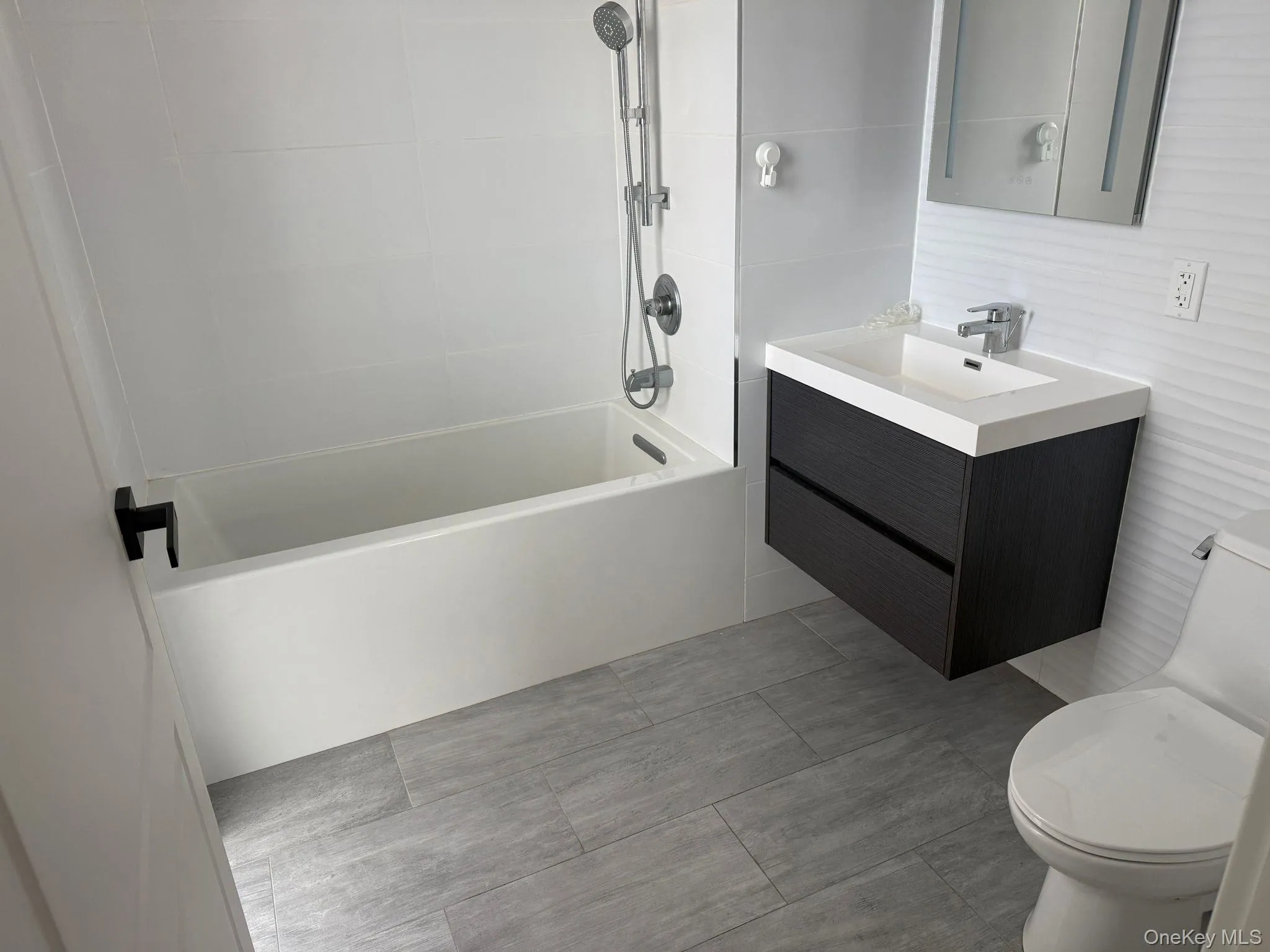 Full bathroom featuring vanity and shower / bath combination Full bathroom featuring vanity and shower / bath combination