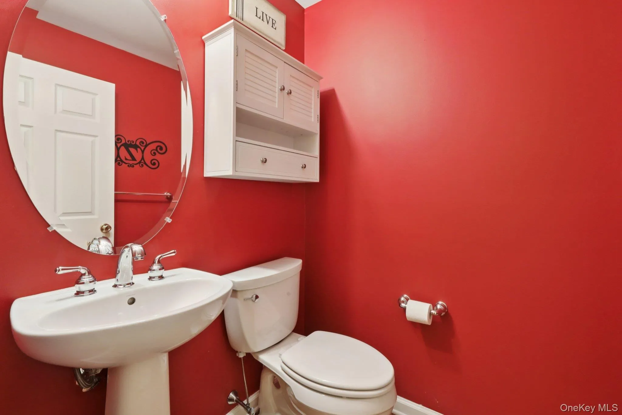 Half bathroom featuring toilet and baseboards Half bathroom featuring toilet and baseboards