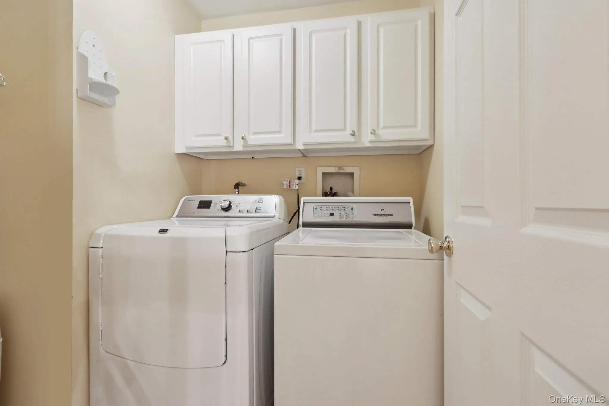 Laundry room with washer and clothes dryer and cabinet space Laundry room with washer and clothes dryer and cabinet space