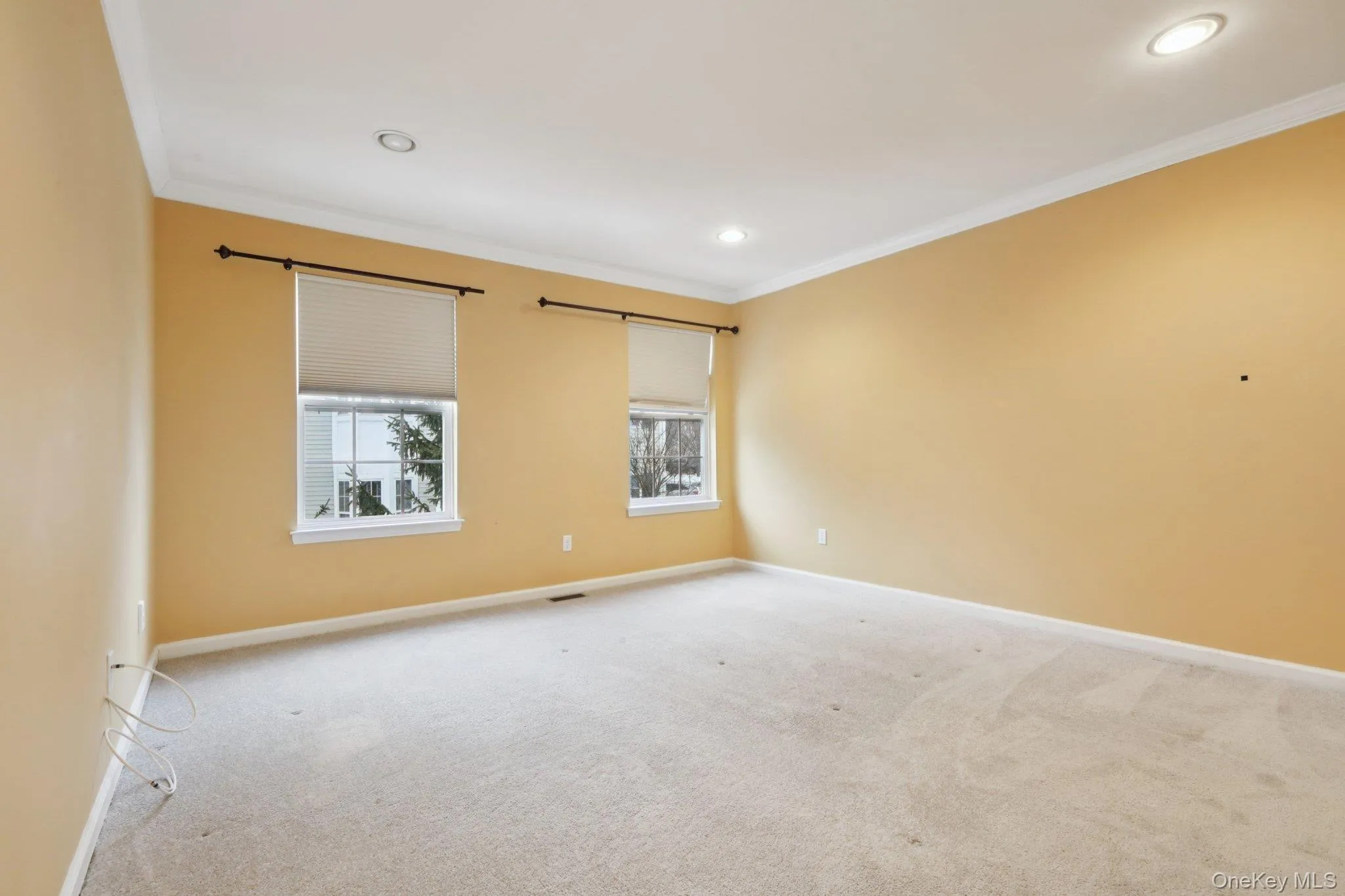 Primary Bedroom with light carpet, ornamental molding, and recessed lighting Primary Bedroom with light carpet, ornamental molding, and recessed lighting