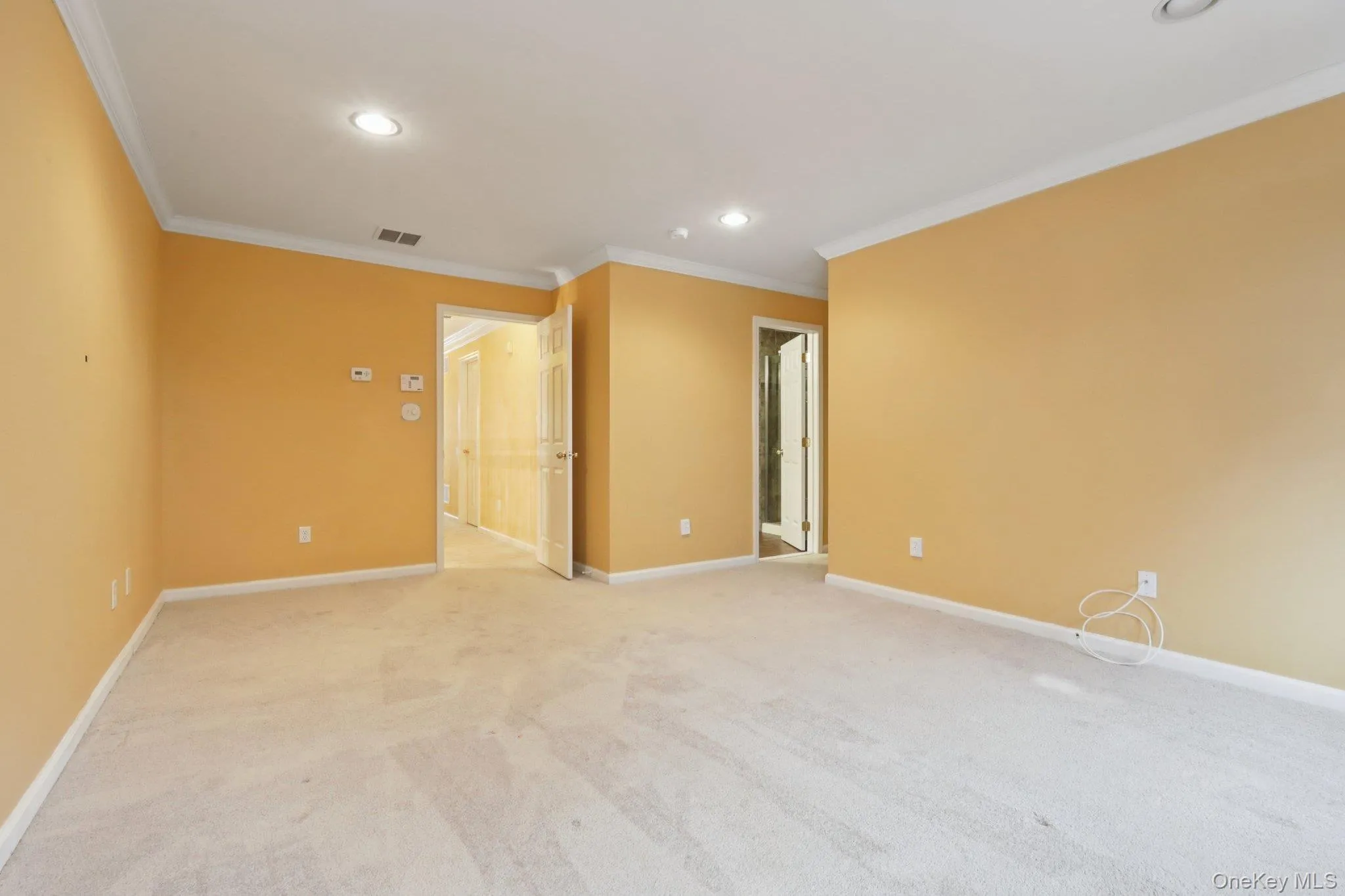 Primary bedroom with carpet, crown molding, and recessed lighting Primary bedroom with carpet, crown molding, and recessed lighting