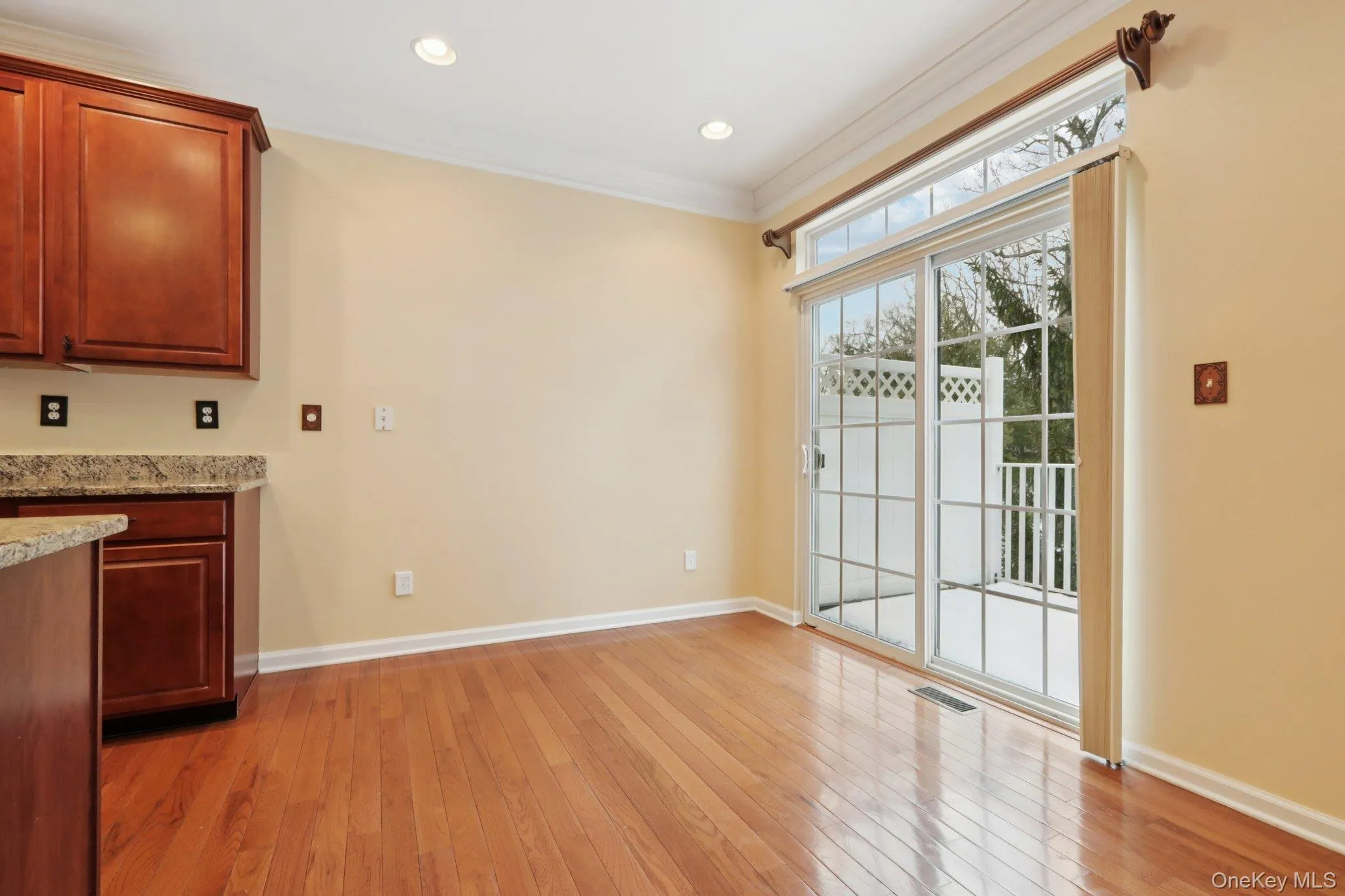 dining area featuring light wood finished floors, crown molding, and recessed lighting dining area featuring light wood finished floors, crown molding, and recessed lighting