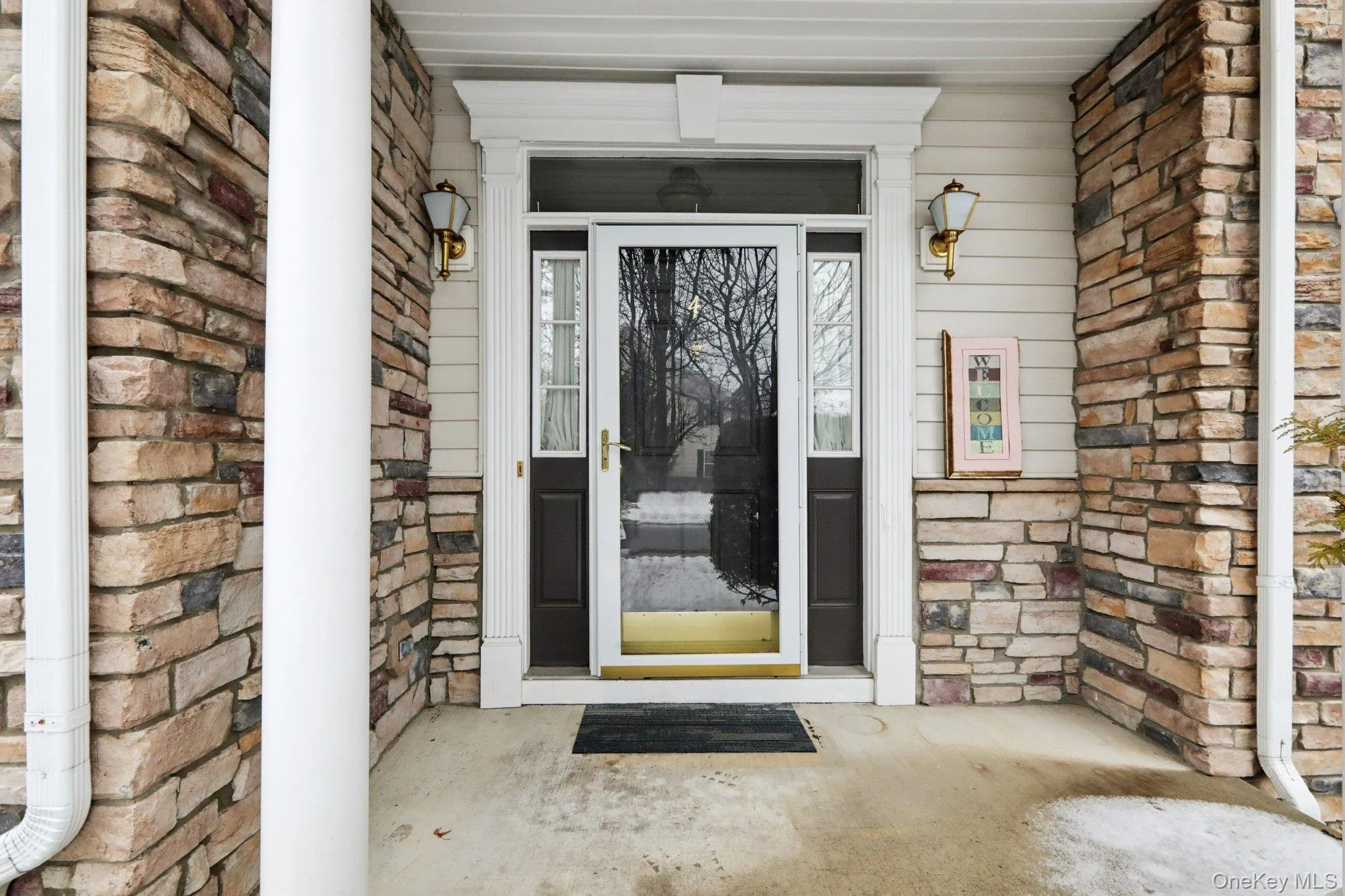 Property entrance featuring stone siding and covered porch Property entrance featuring stone siding and covered porch