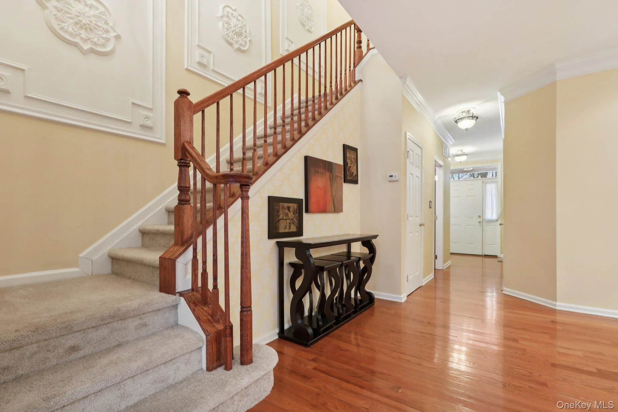 Stairs with hardwood flooring and crown molding Stairs with hardwood flooring and crown molding