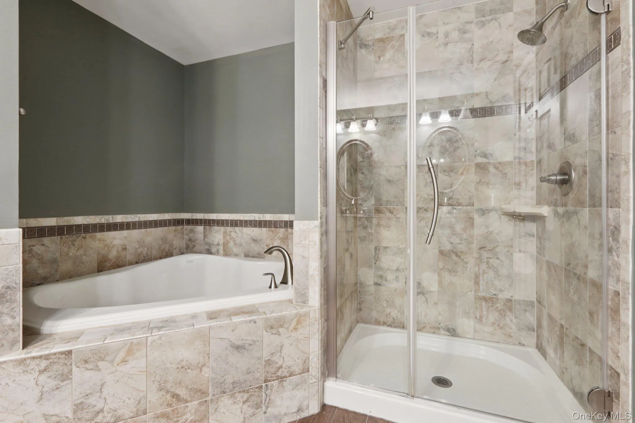 Full bathroom featuring a stall shower and a bath Full bathroom featuring a stall shower and a bath