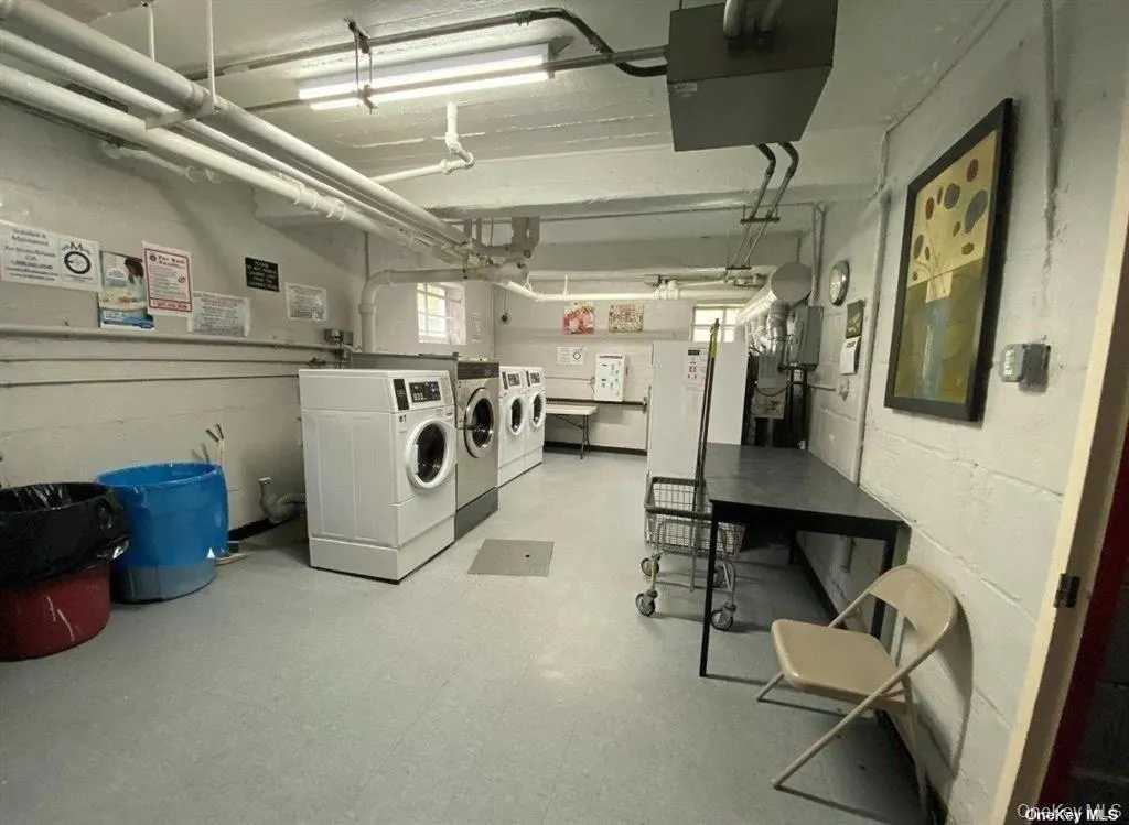 Shared laundry featuring a heating unit and washing machine and clothes dryer Shared laundry featuring a heating unit and washing machine and clothes dryer