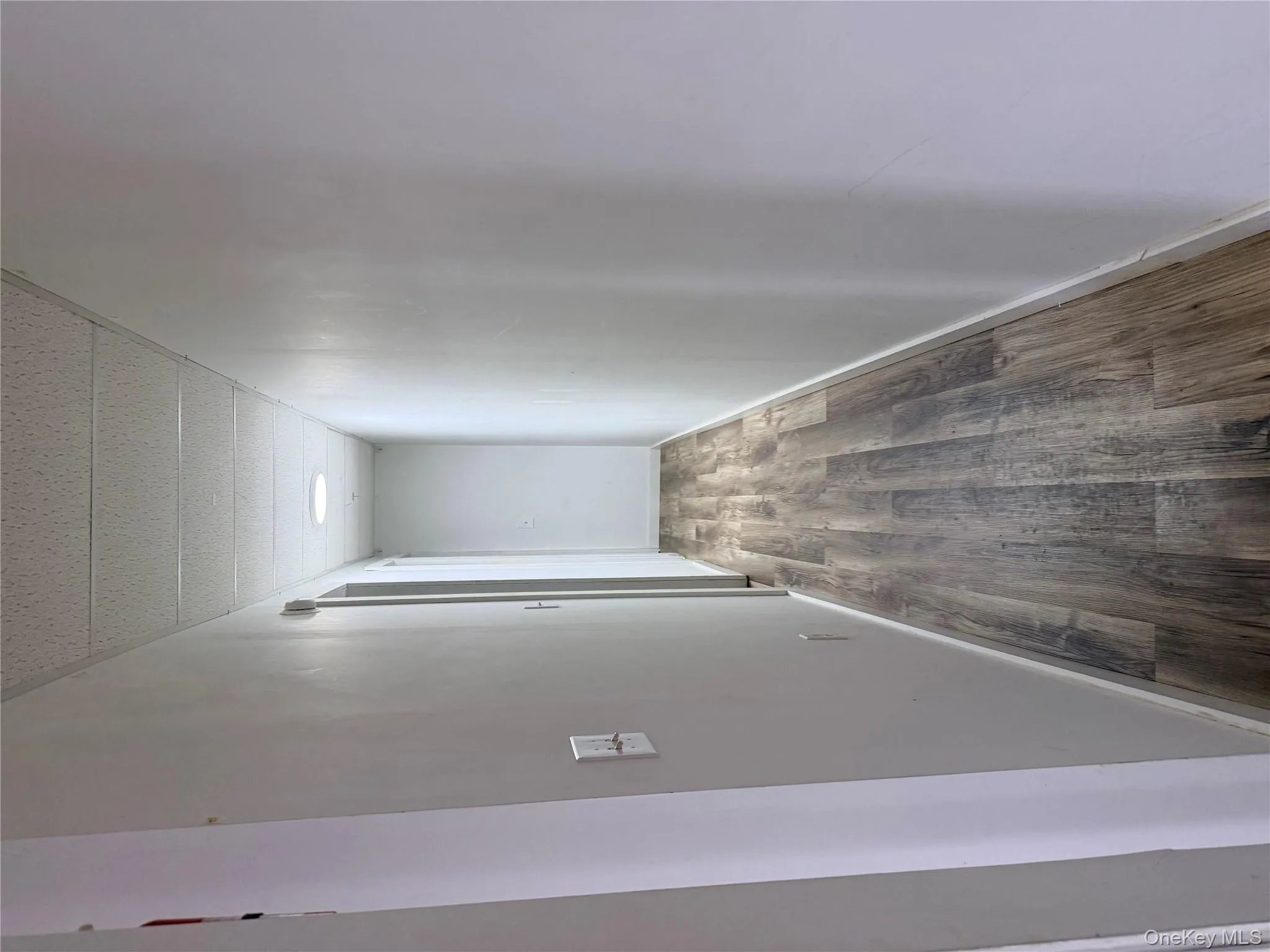 Hall featuring dark wood-style floors and a drop ceiling Hall featuring dark wood-style floors and a drop ceiling