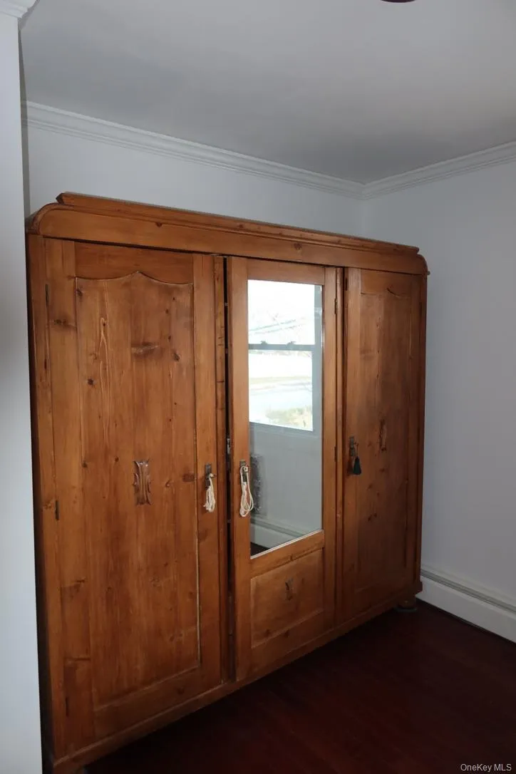 Closet featuring a baseboard heating unit Closet featuring a baseboard heating unit
