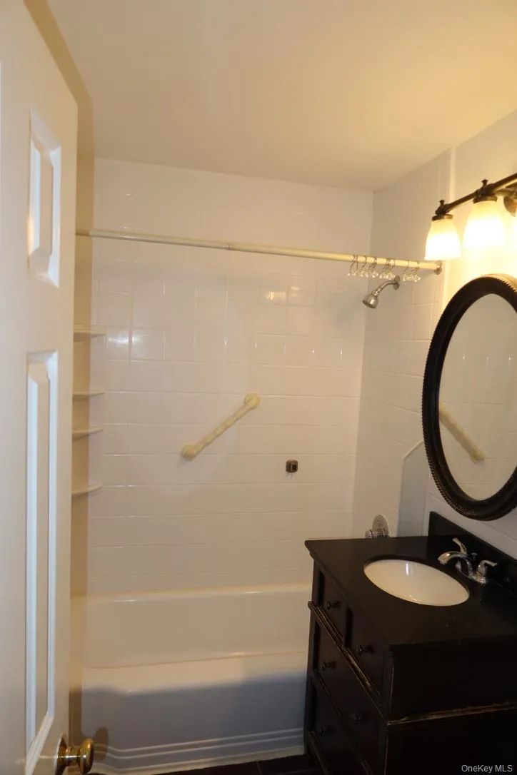 Full bathroom featuring vanity and shower / washtub combination Full bathroom featuring vanity and shower / washtub combination