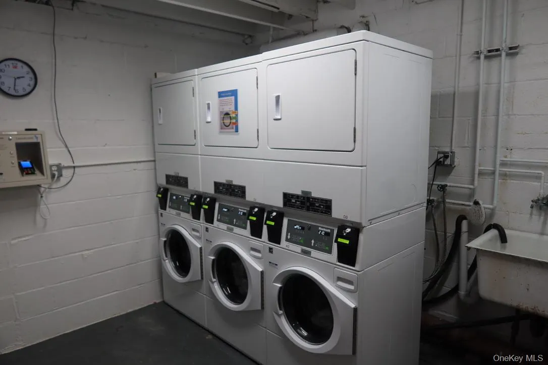 Shared laundry featuring stacked washer and clothes dryer Shared laundry featuring stacked washer and clothes dryer