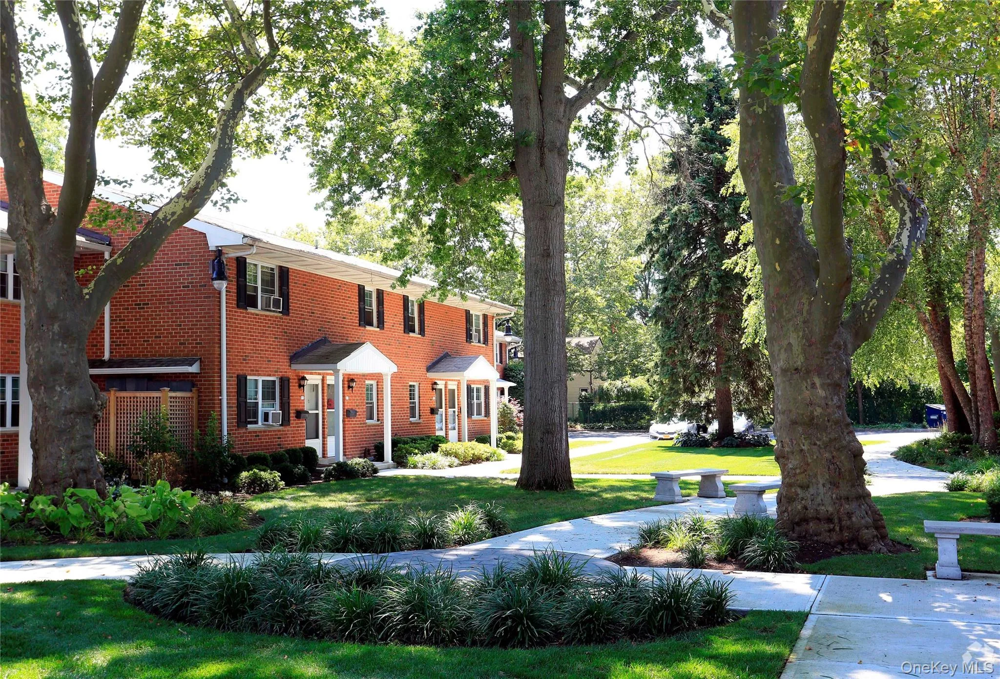 View of front facade featuring a front yard and brick siding View of front facade featuring a front yard and brick siding