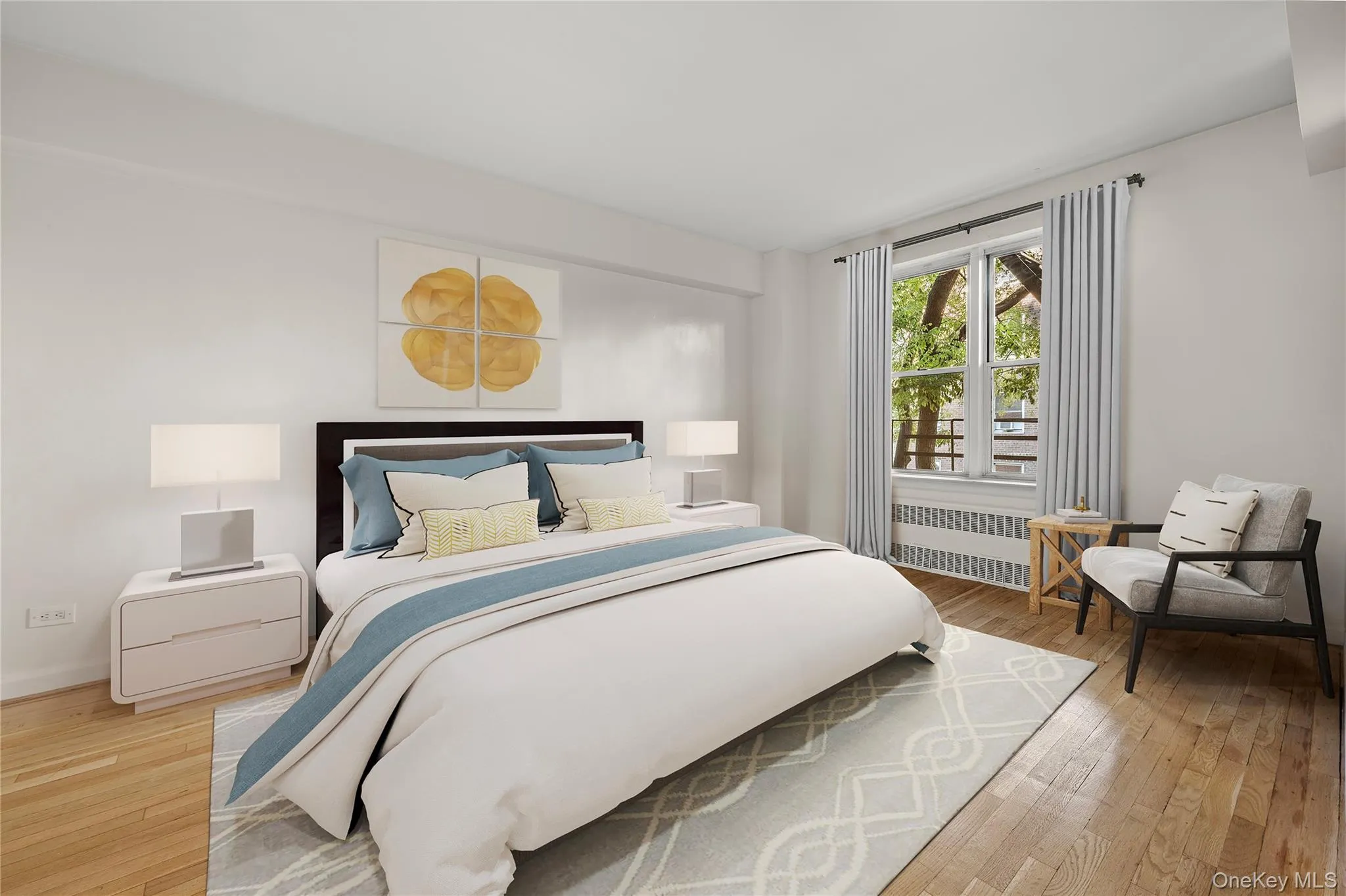 Bedroom featuring hardwood / wood-style floors and radiator Bedroom featuring hardwood / wood-style floors and radiator