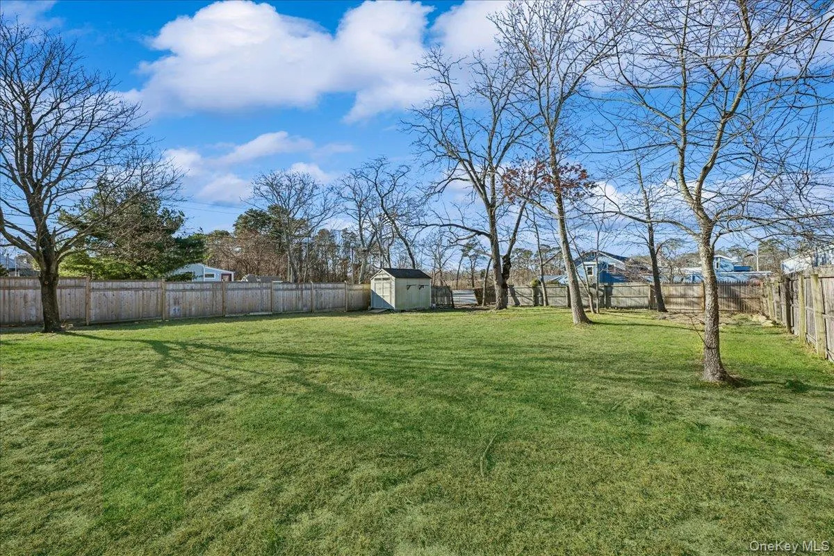 Fenced backyard with a shed Fenced backyard with a shed