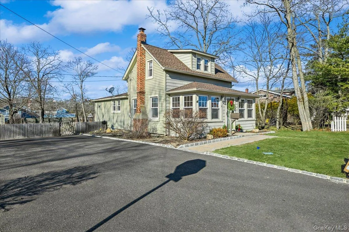 View of front of house featuring a chimney and a shingled roof View of front of house featuring a chimney and a shingled roof