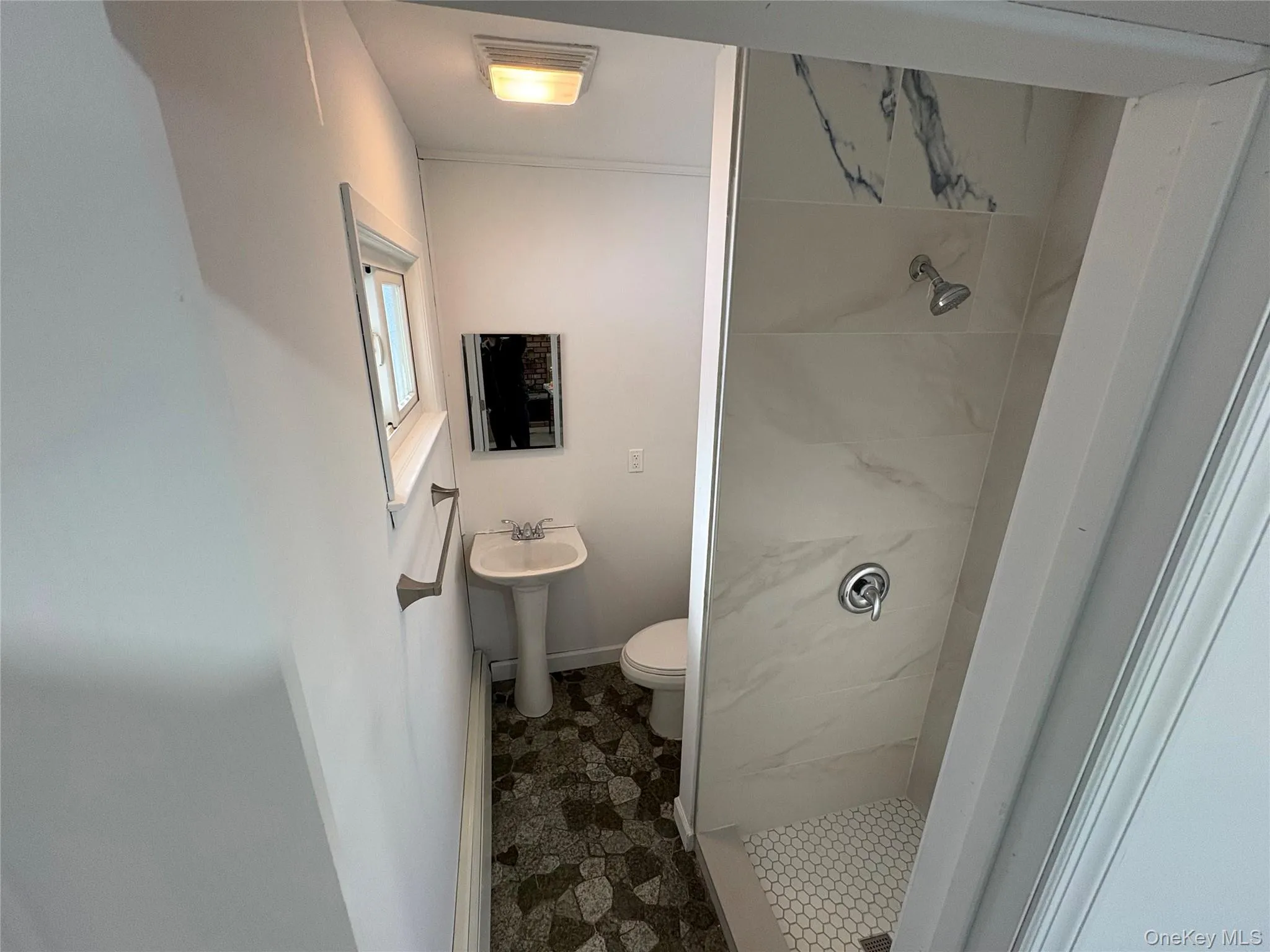 Bathroom with a stall shower and toilet Bathroom with a stall shower and toilet