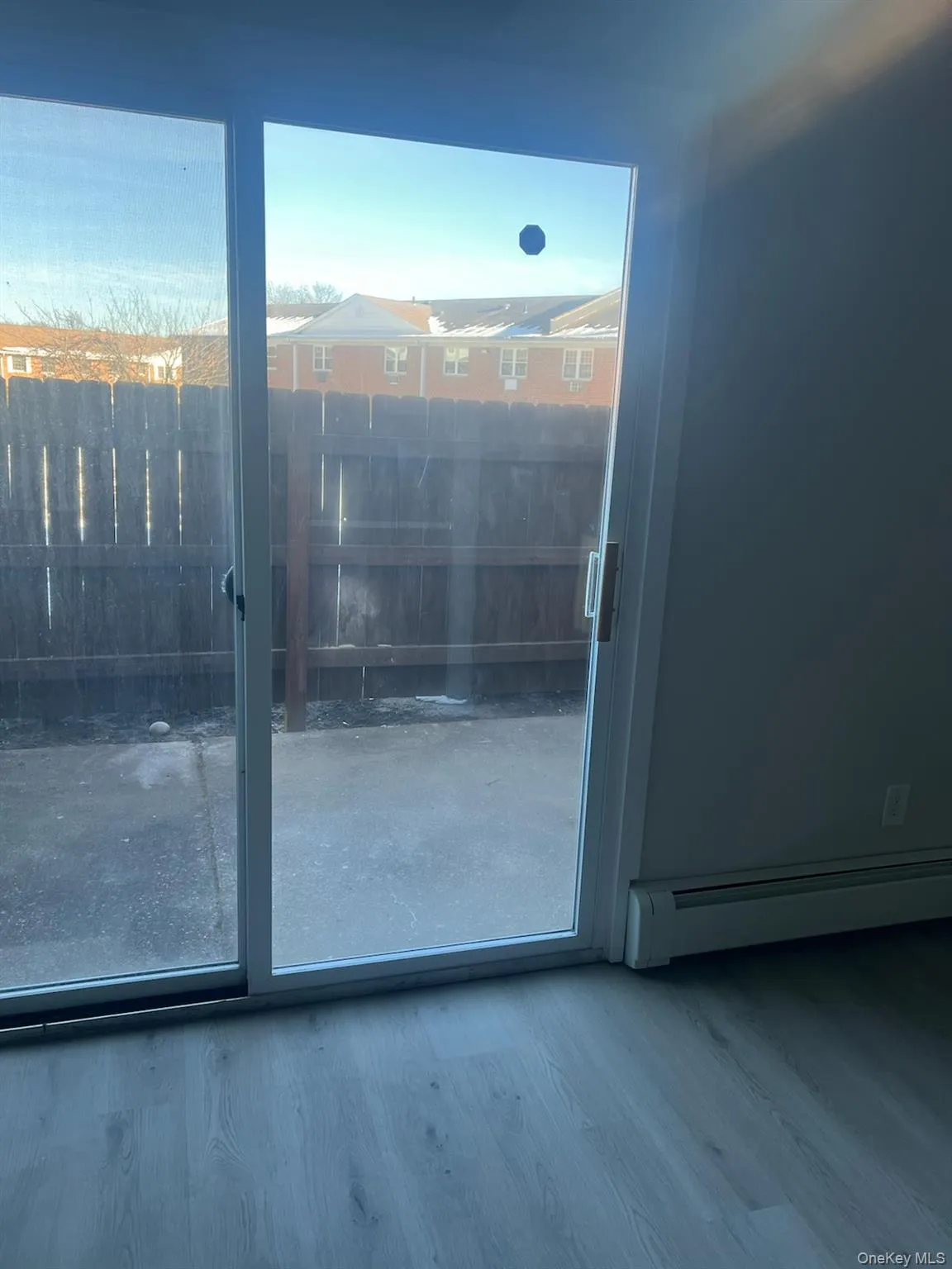 Doorway featuring a baseboard radiator and wood finished floors Doorway featuring a baseboard radiator and wood finished floors