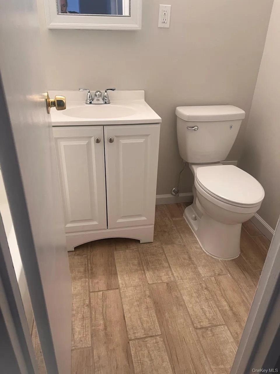 Half bath featuring toilet and vanity Half bath featuring toilet and vanity