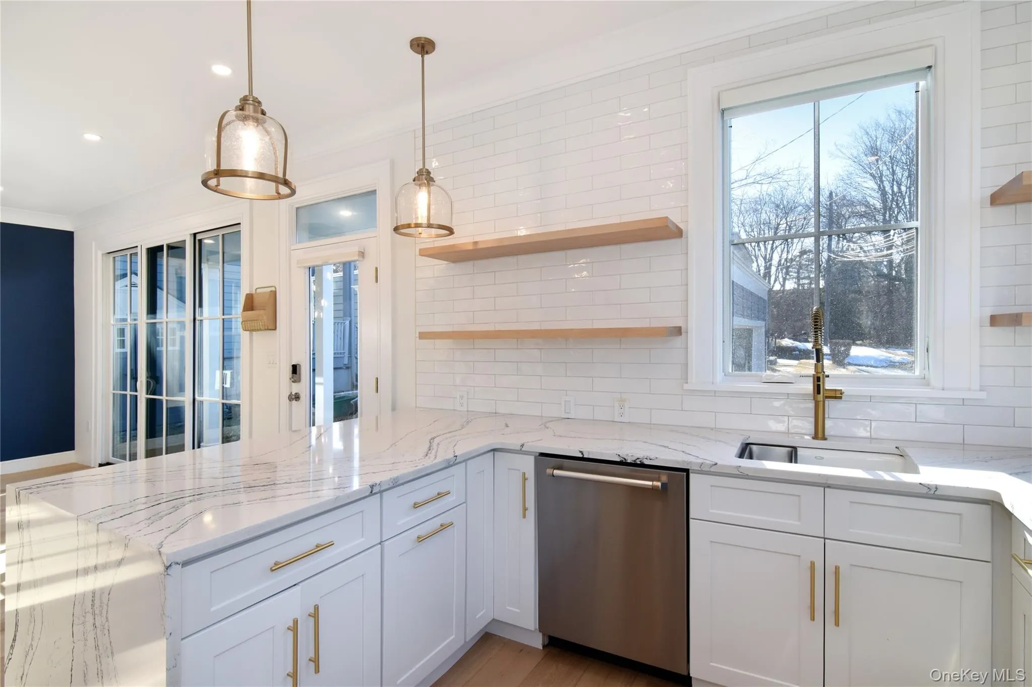 This side of the kitchen emphasizes the generous counter space and smooth floor between prep, cleanup and entertaining areas. This side of the kitchen emphasizes the generous counter space and smooth floor between prep, cleanup and entertaining areas.