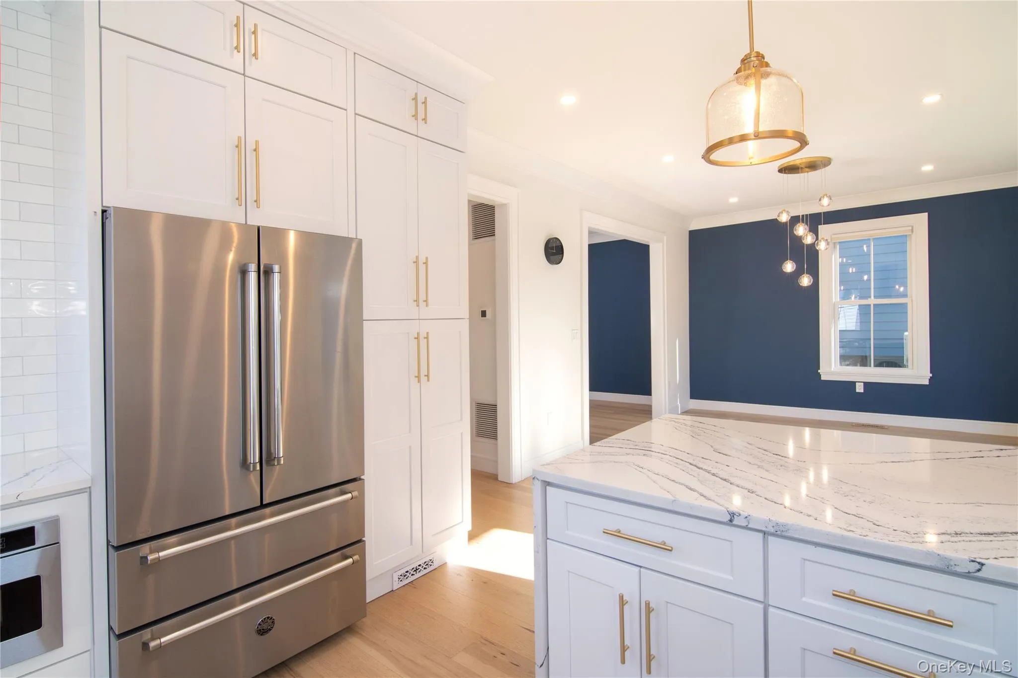 Look outward from the kitchen to the dining room’s rich accent wall adding depth and character. Look outward from the kitchen to the dining room’s rich accent wall adding depth and character.