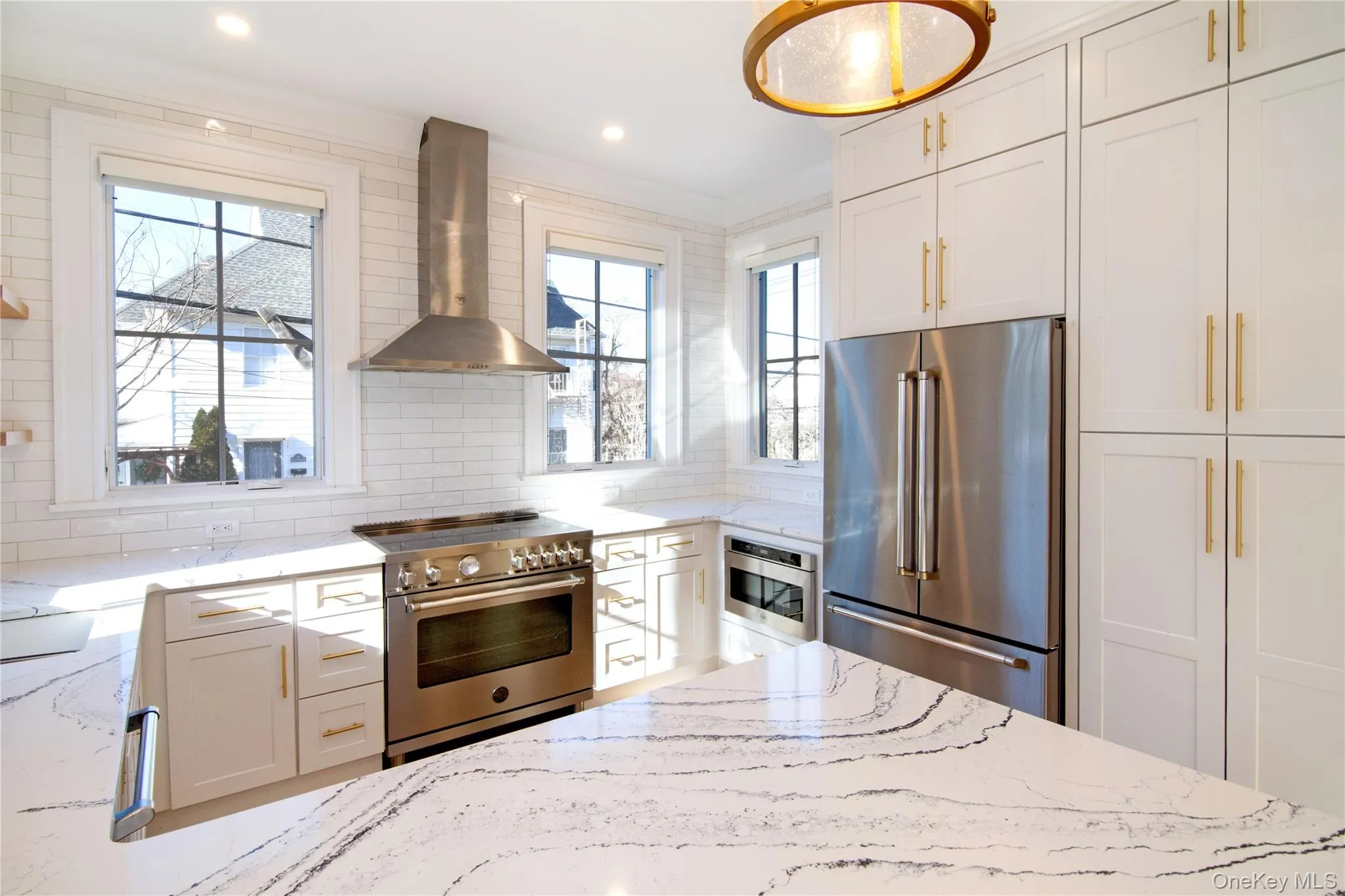 This view highlights the custom cabinetry and full height pantry, offering generous storage while maintaining a clean seamless look This view highlights the custom cabinetry and full height pantry, offering generous storage while maintaining a clean seamless look