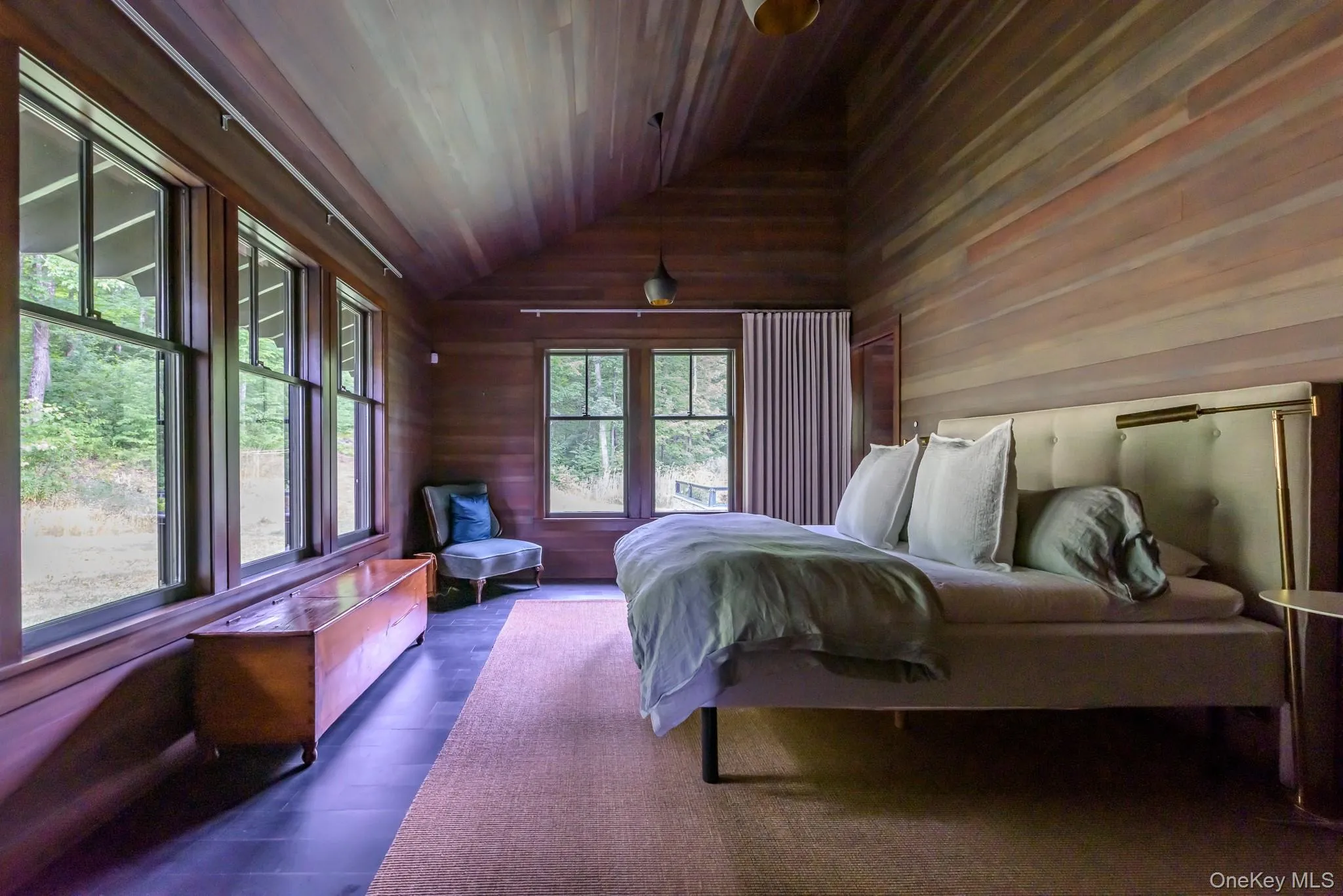 Bedroom featuring wood ceiling, vaulted ceiling, hardwood / wood-style flooring, and wood walls Bedroom featuring wood ceiling, vaulted ceiling, hardwood / wood-style flooring, and wood walls