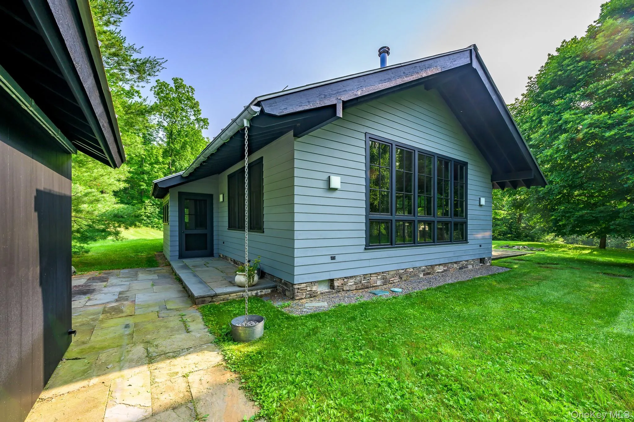 View of side of home with a lawn and a patio area View of side of home with a lawn and a patio area