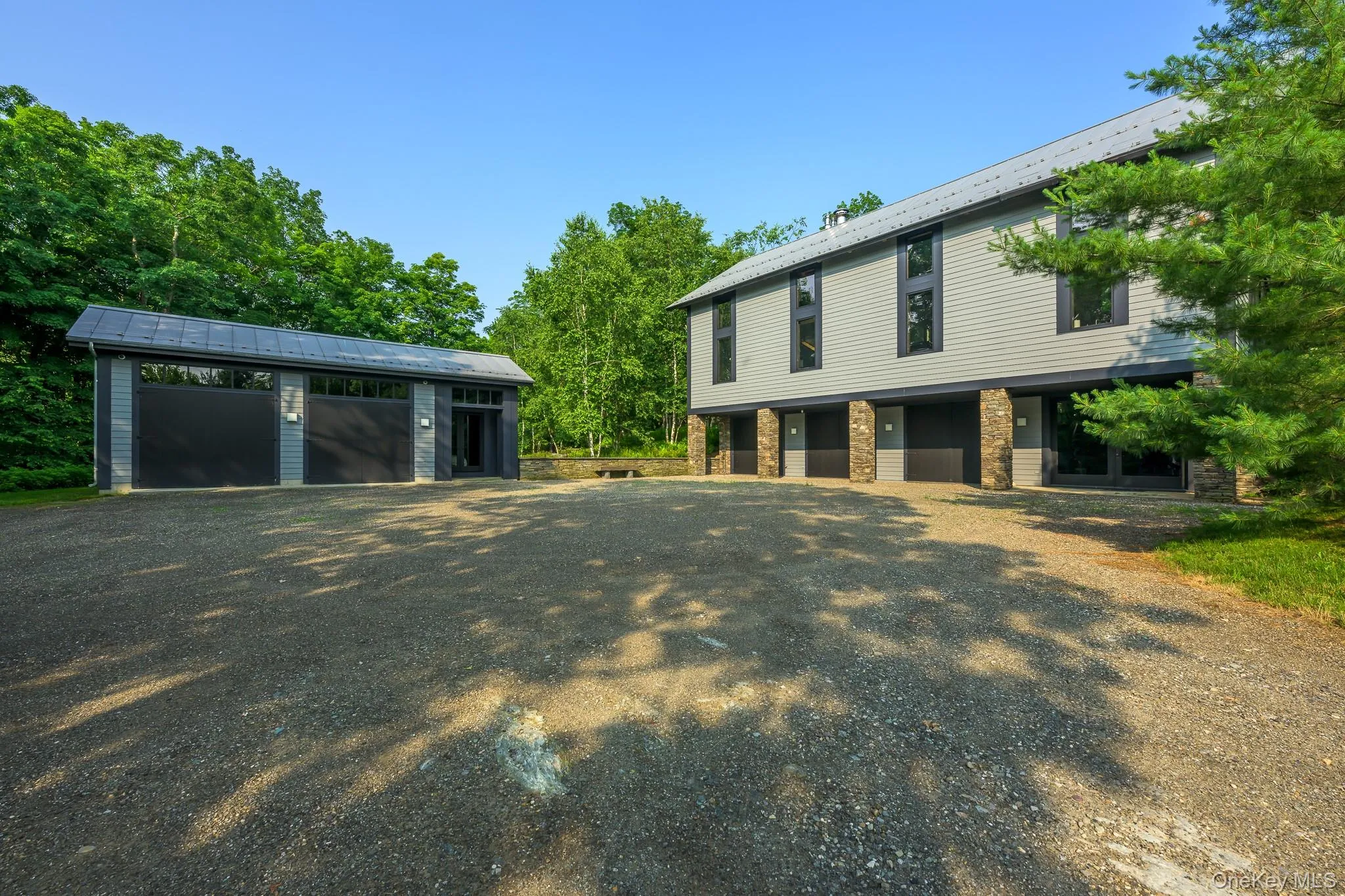 View of front of property featuring an outbuilding and a garage View of front of property featuring an outbuilding and a garage