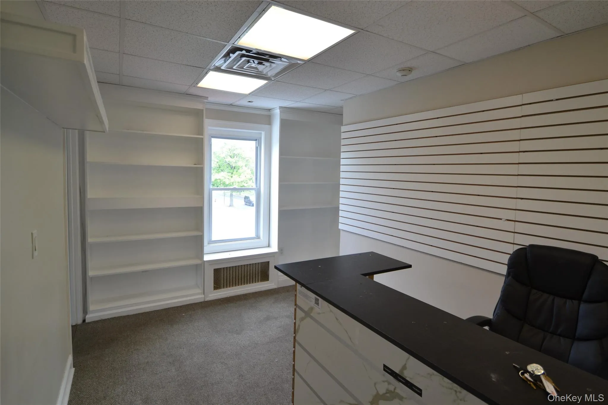 Office space featuring a drop ceiling Office space featuring a drop ceiling