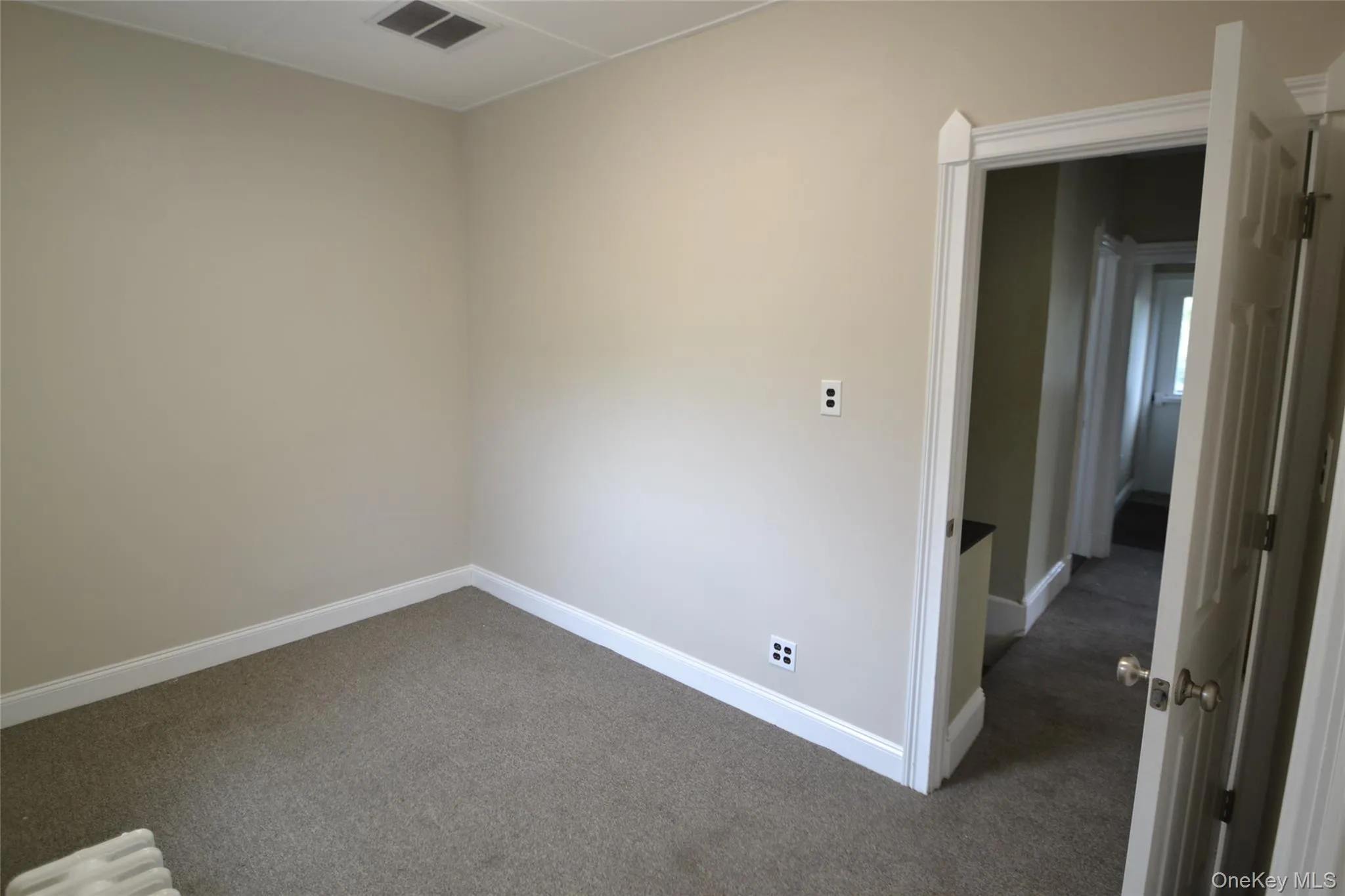 Unfurnished room featuring carpet floors and baseboards Unfurnished room featuring carpet floors and baseboards