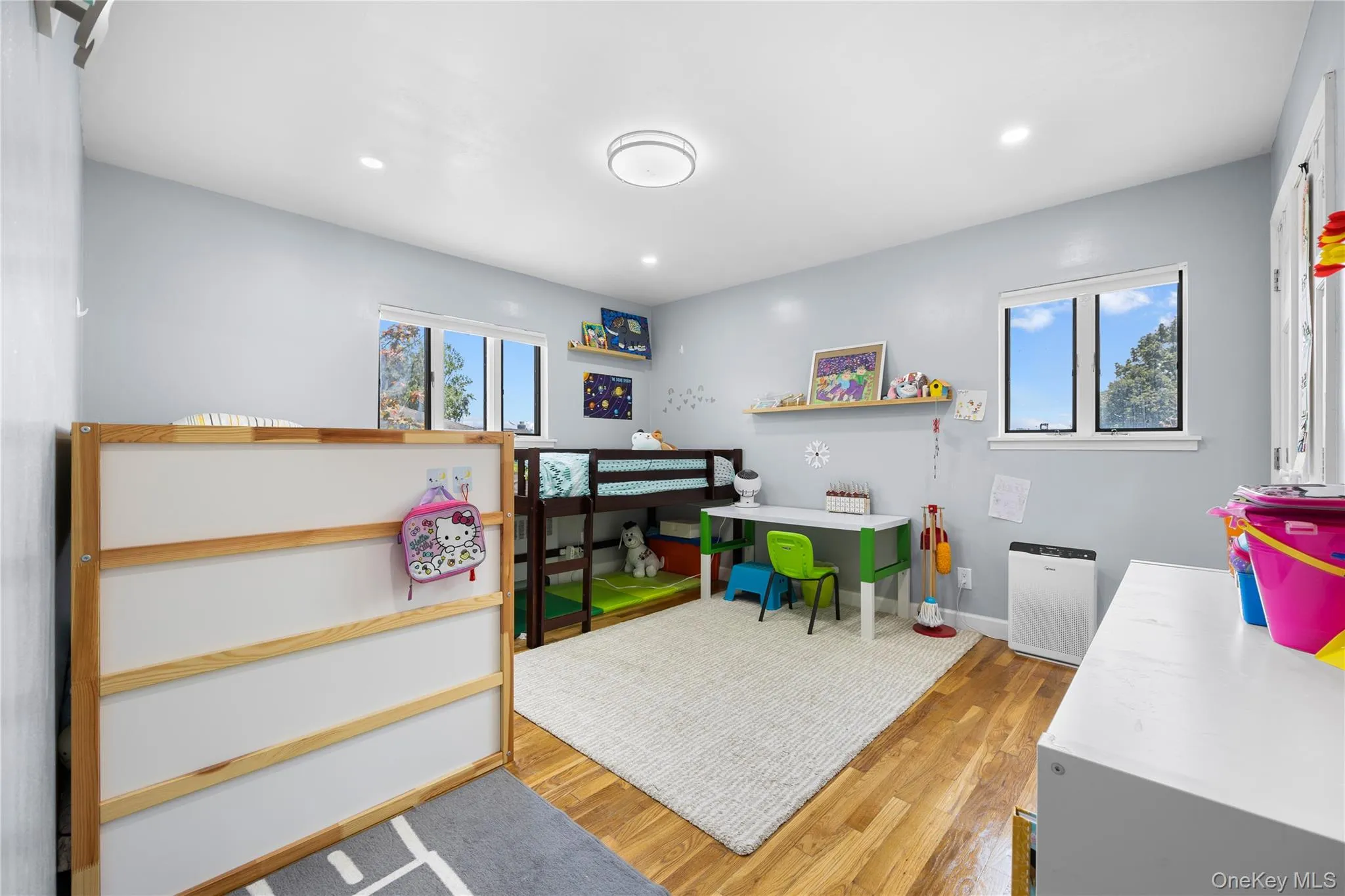 Bedroom with light wood finished floors, multiple windows, and recessed lighting Bedroom with light wood finished floors, multiple windows, and recessed lighting