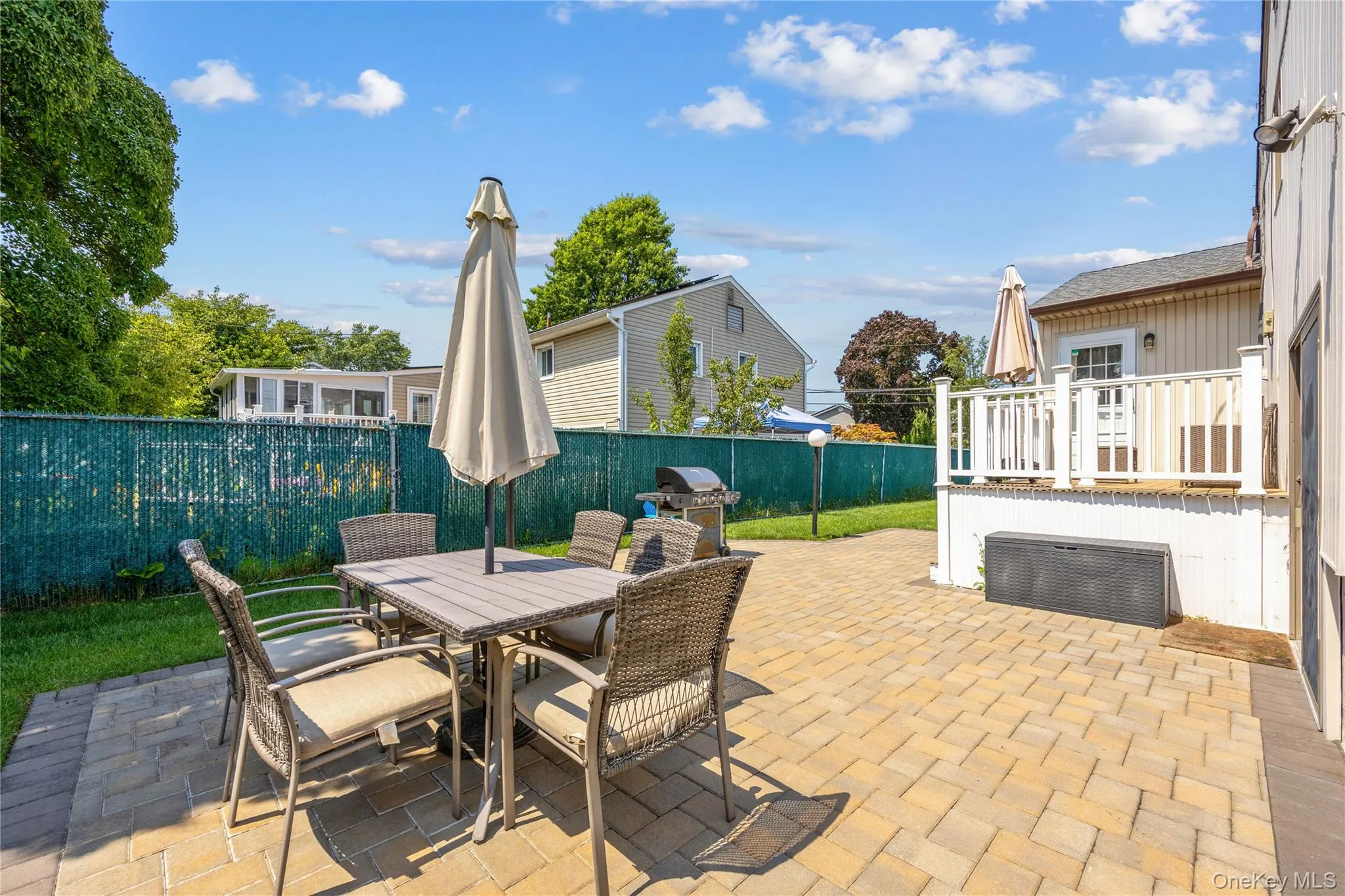 Fenced backyard with a patio area, outdoor dining area, and a grill Fenced backyard with a patio area, outdoor dining area, and a grill