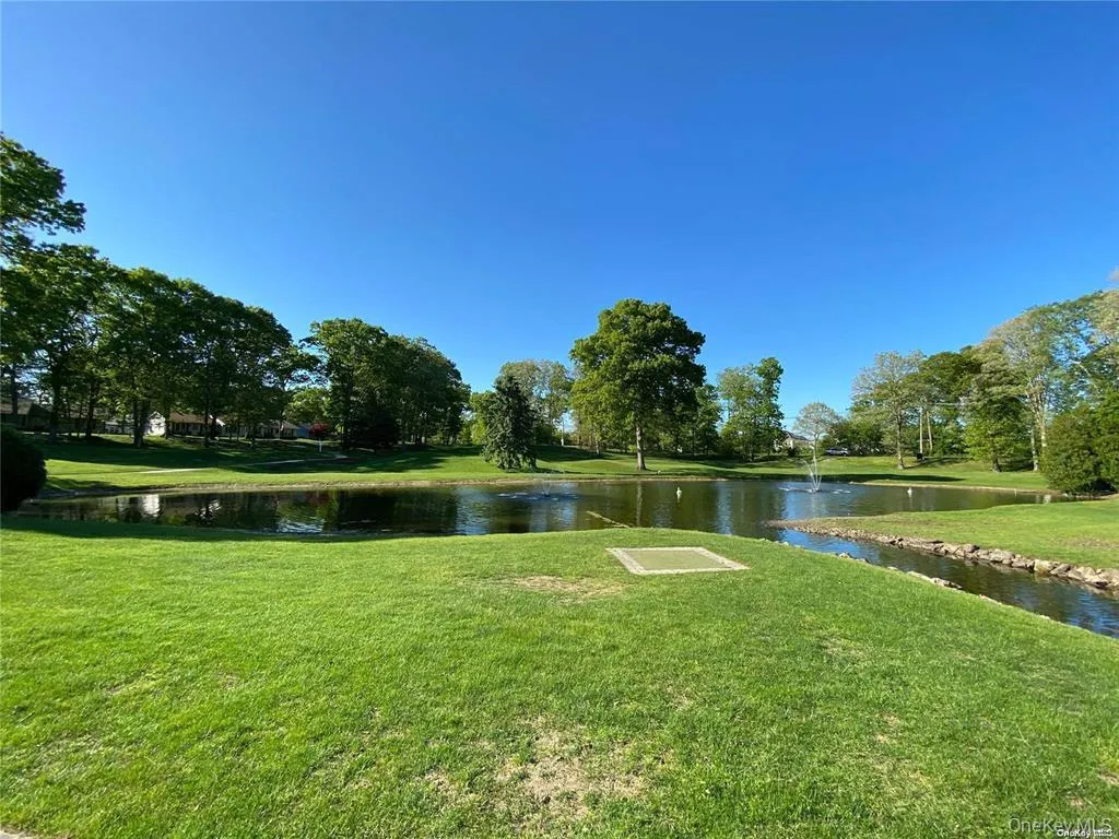 View of community featuring a water view and a lawn View of community featuring a water view and a lawn