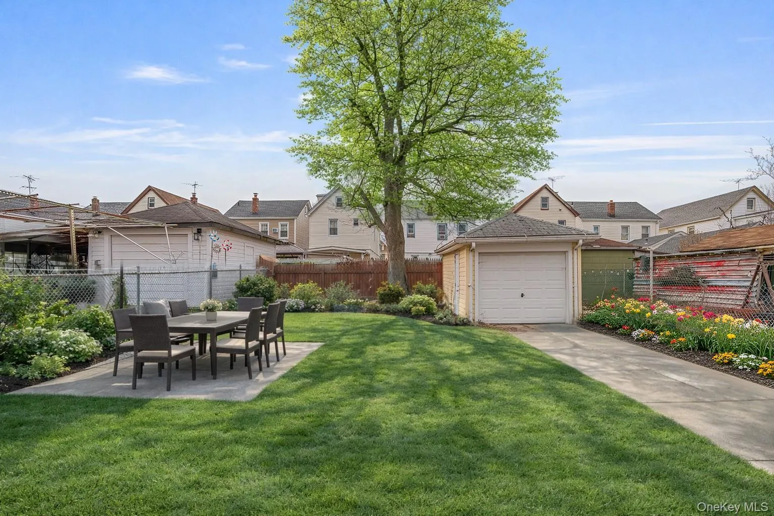 View of yard with a residential view, an outbuilding, and a patio View of yard with a residential view, an outbuilding, and a patio