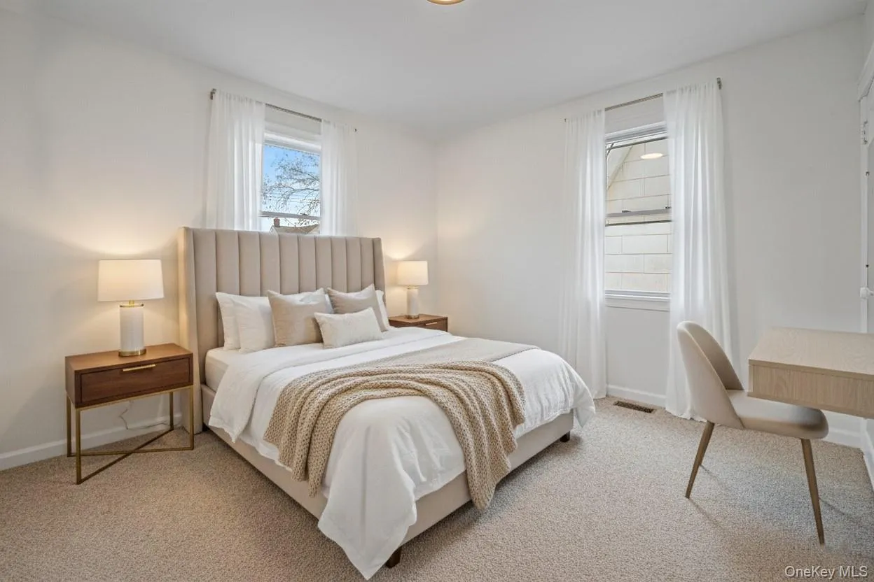 Bedroom featuring light carpet Bedroom featuring light carpet