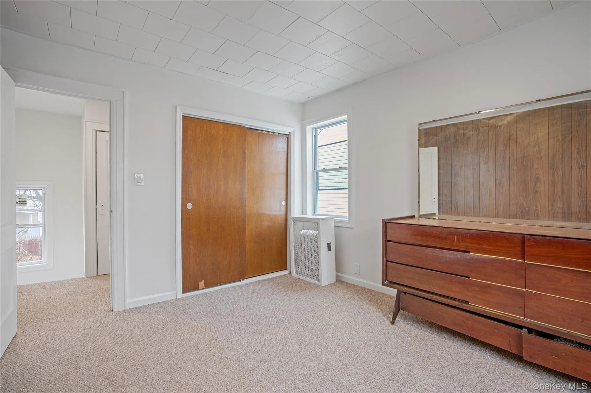 Unfurnished bedroom with a closet and light carpet Unfurnished bedroom with a closet and light carpet