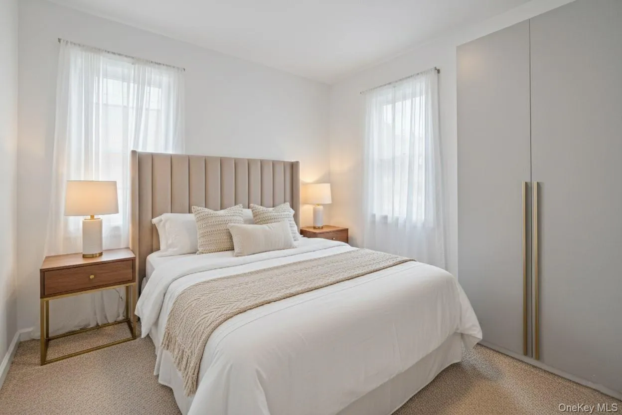 Bedroom featuring carpet and multiple windows Bedroom featuring carpet and multiple windows