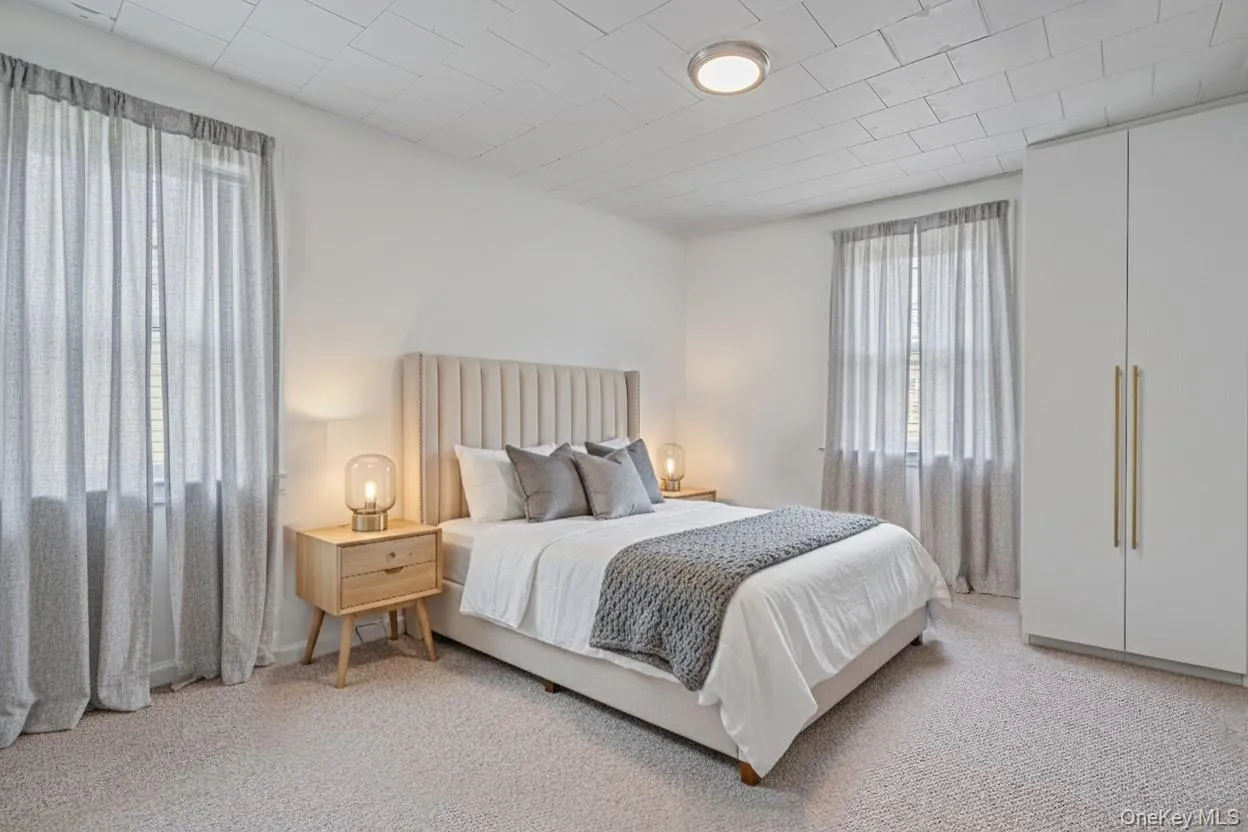 Bedroom featuring light colored carpet Bedroom featuring light colored carpet