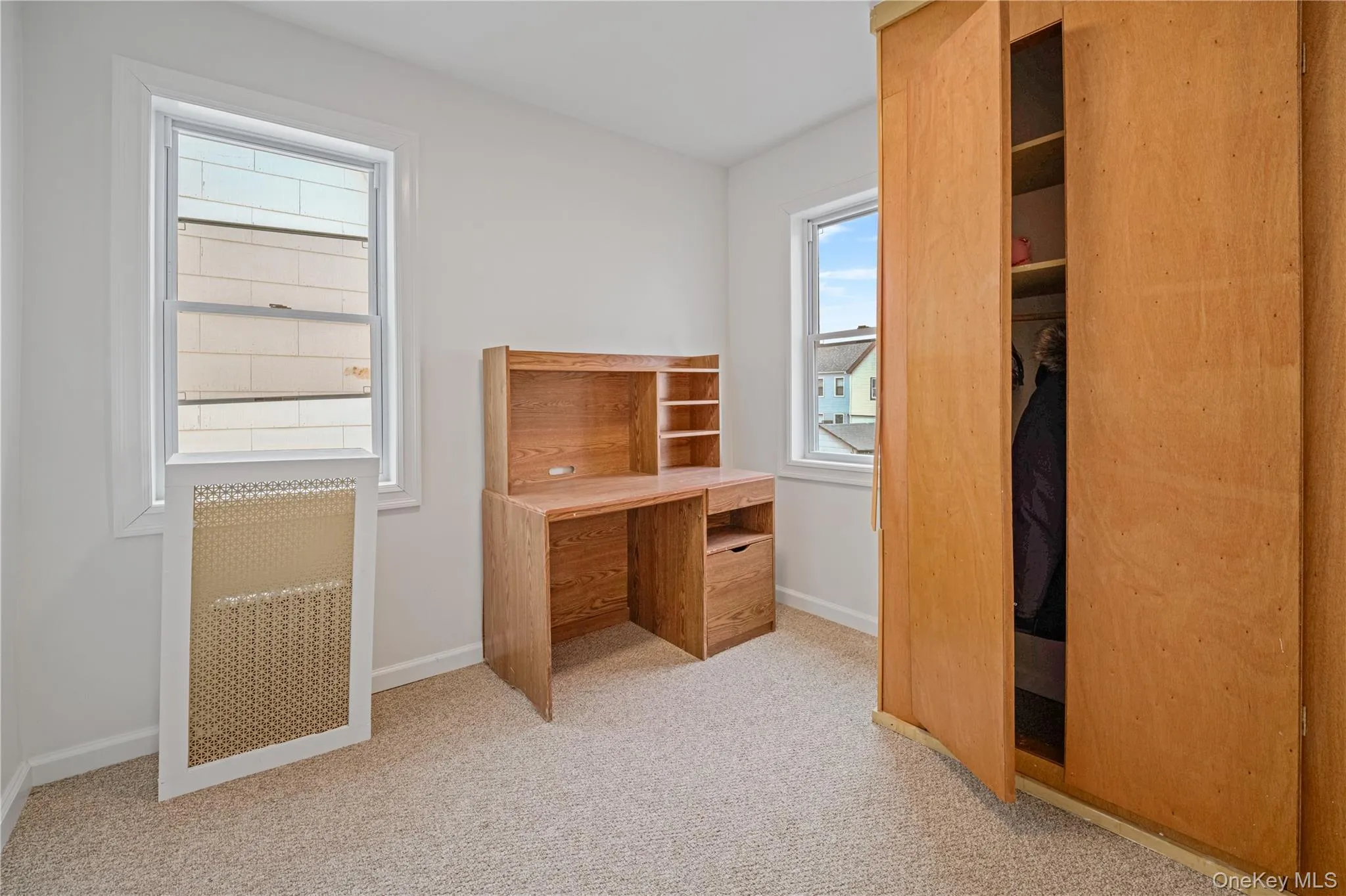 Unfurnished bedroom featuring baseboards and light colored carpet Unfurnished bedroom featuring baseboards and light colored carpet