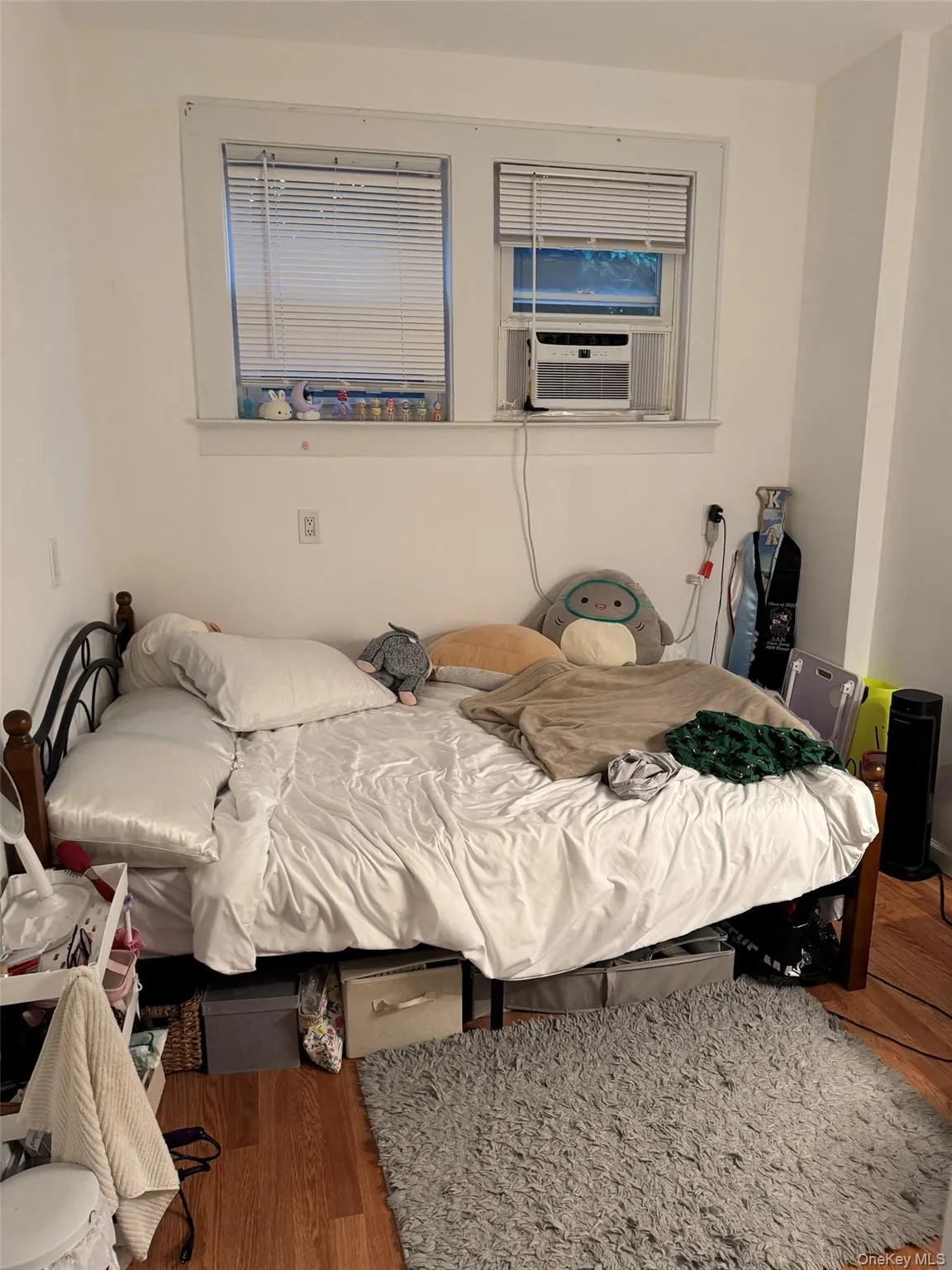 Bedroom with cooling unit and wood finished floors Bedroom with cooling unit and wood finished floors