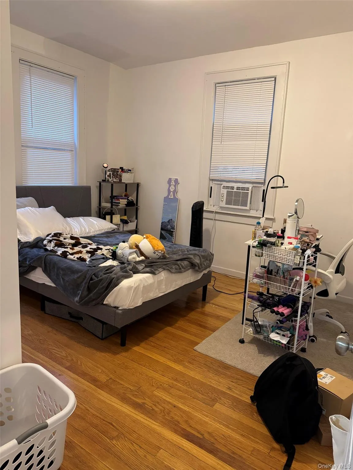 Bedroom with cooling unit and wood finished floors Bedroom with cooling unit and wood finished floors