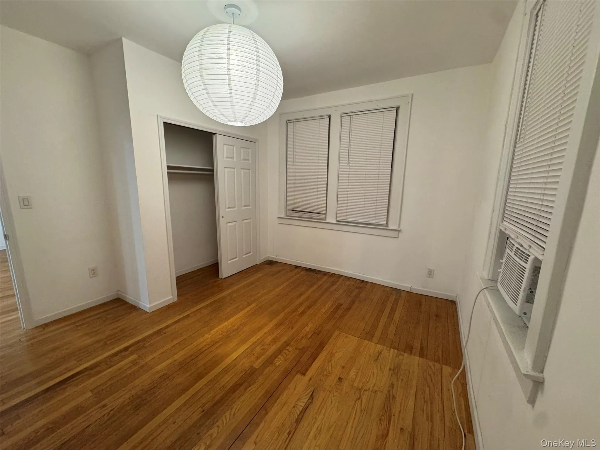 Unfurnished bedroom with light wood-style floors and a closet Unfurnished bedroom with light wood-style floors and a closet