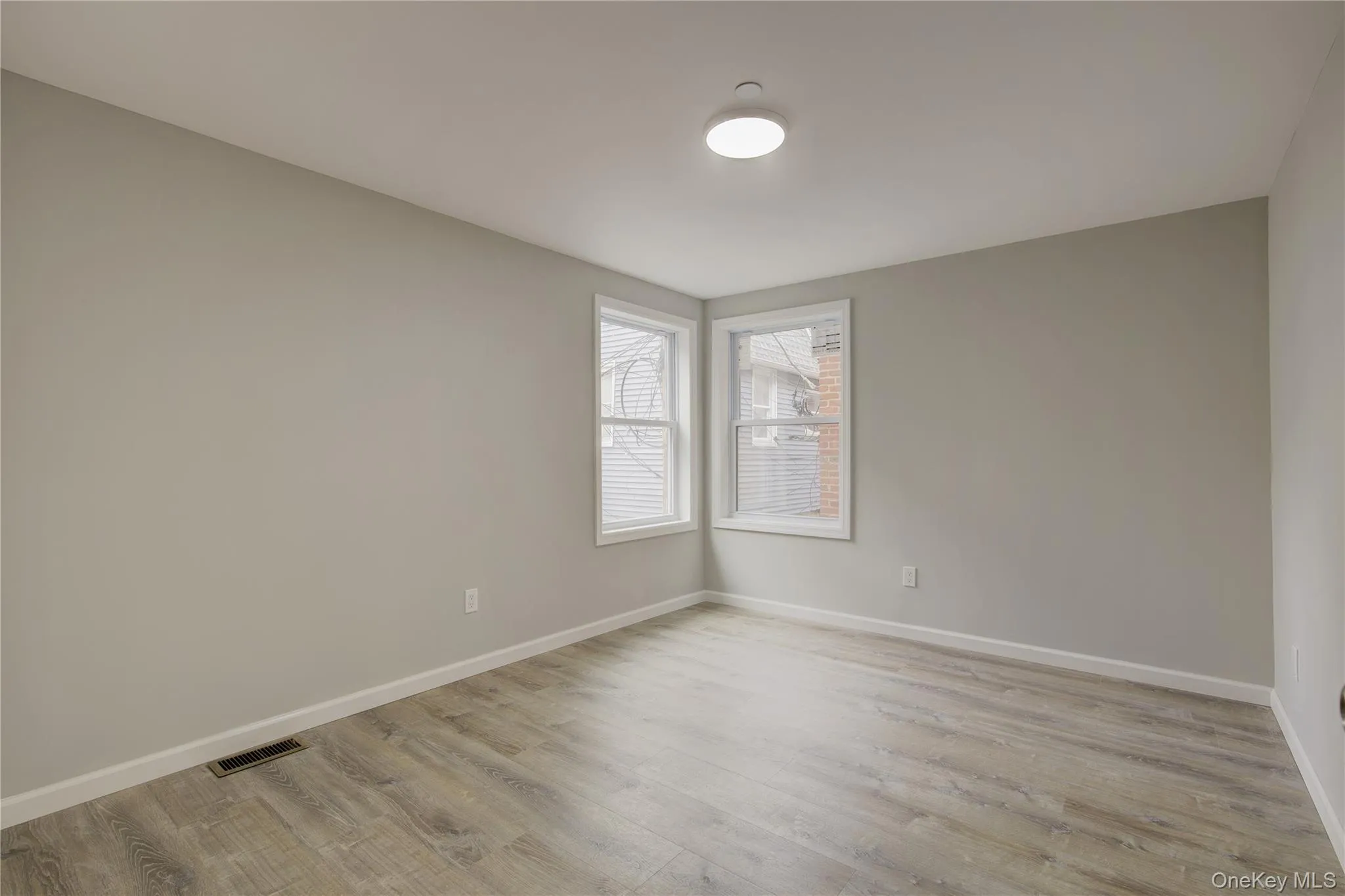 Spare room featuring light wood-type flooring Spare room featuring light wood-type flooring