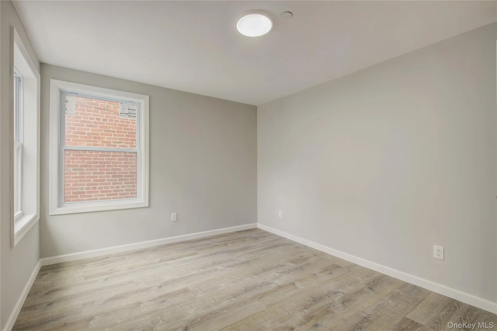 Unfurnished room featuring light wood-type flooring and plenty of natural light Unfurnished room featuring light wood-type flooring and plenty of natural light