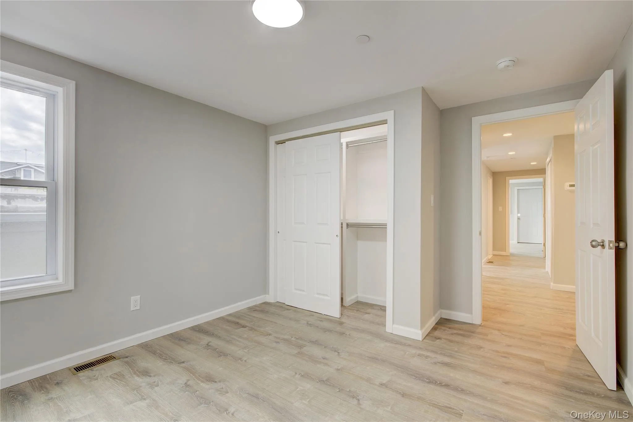 Unfurnished bedroom with light wood-style floors and a closet Unfurnished bedroom with light wood-style floors and a closet