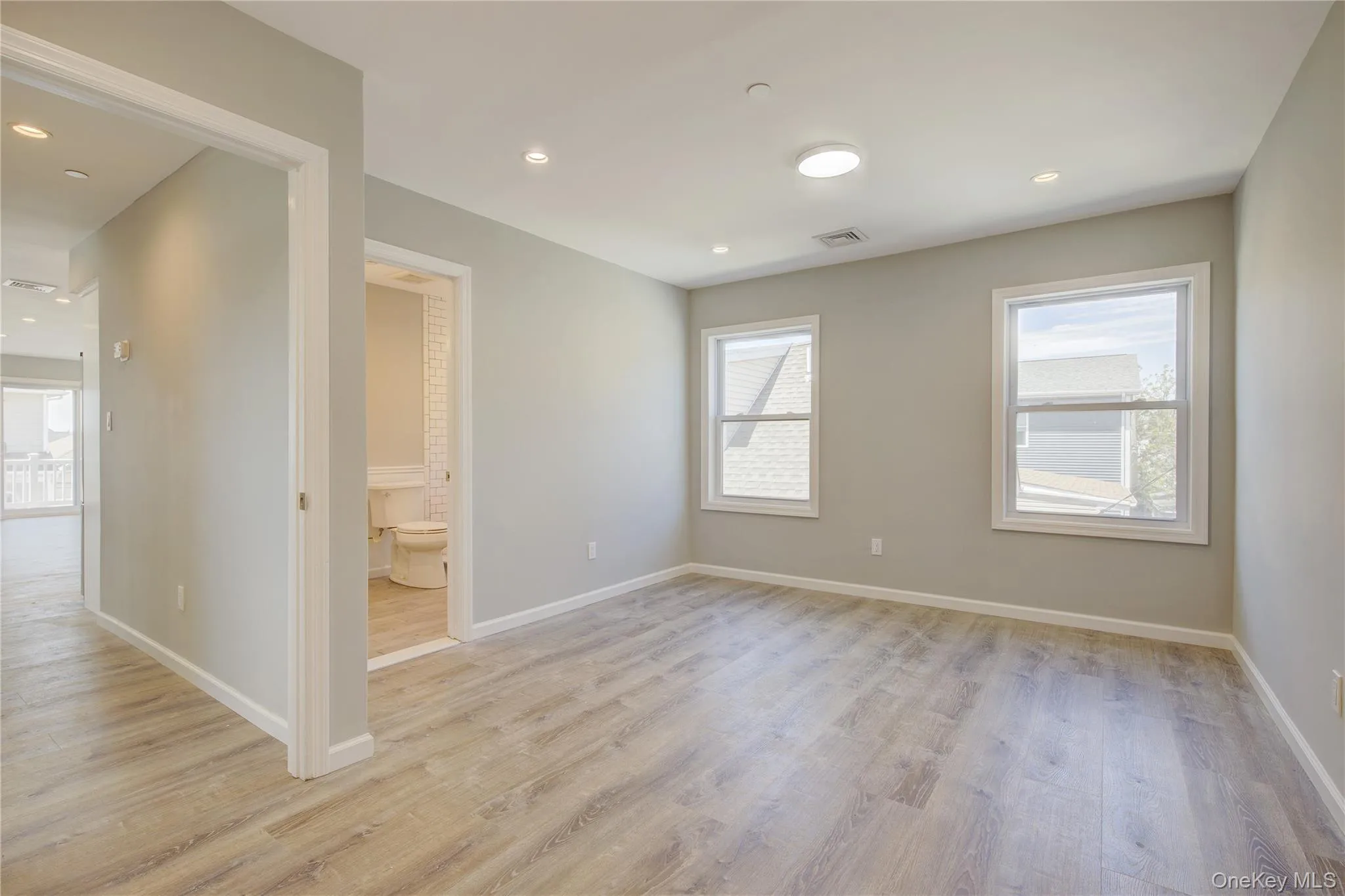 Unfurnished room with light wood-style floors and recessed lighting Unfurnished room with light wood-style floors and recessed lighting