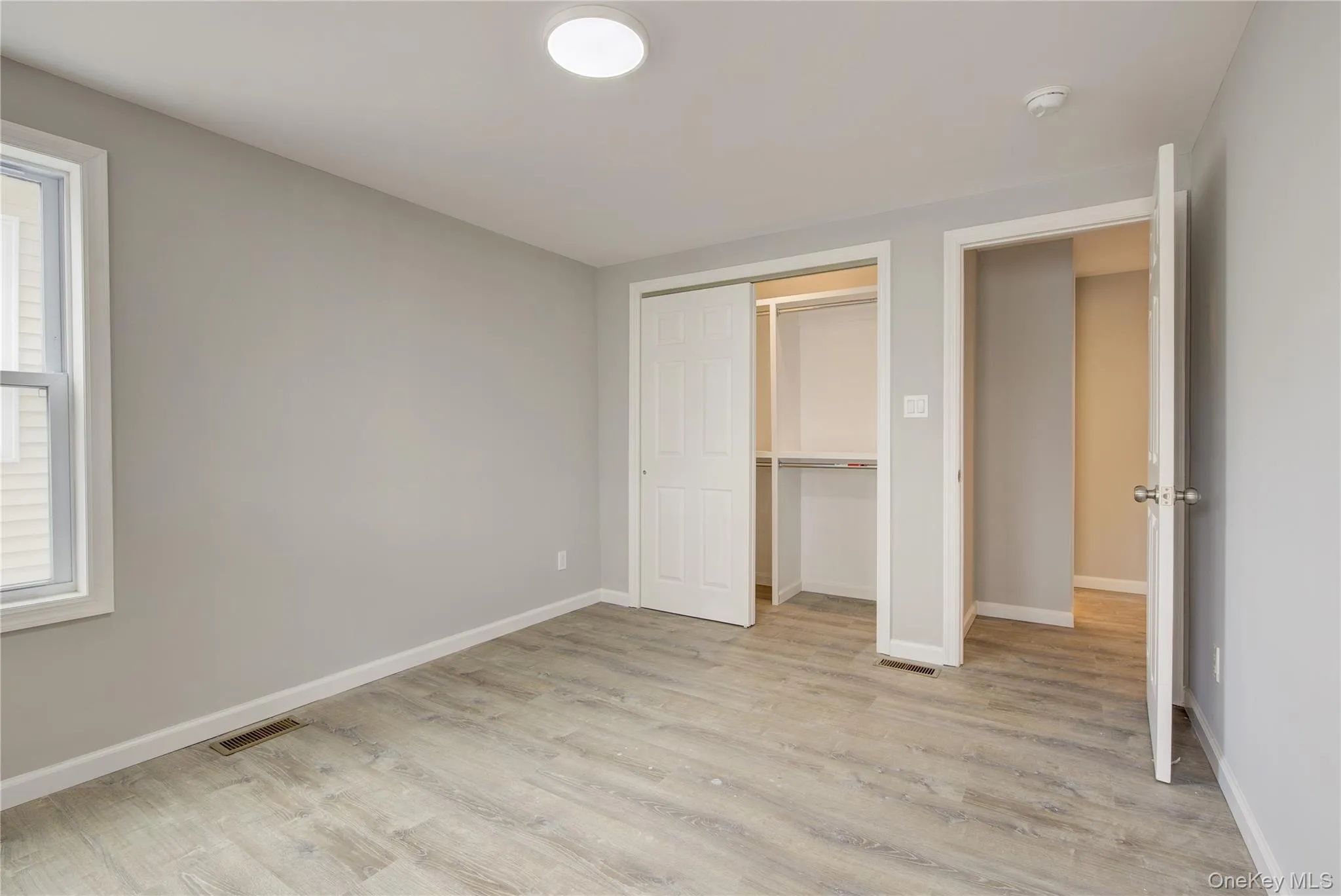 Unfurnished bedroom featuring light wood finished floors and a closet Unfurnished bedroom featuring light wood finished floors and a closet