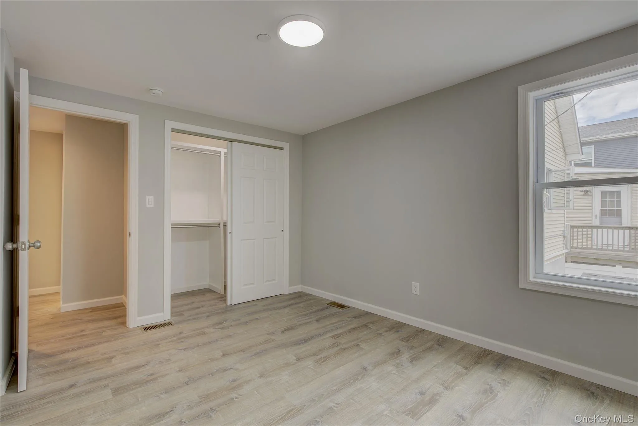 Unfurnished bedroom with light wood-style floors and a closet Unfurnished bedroom with light wood-style floors and a closet