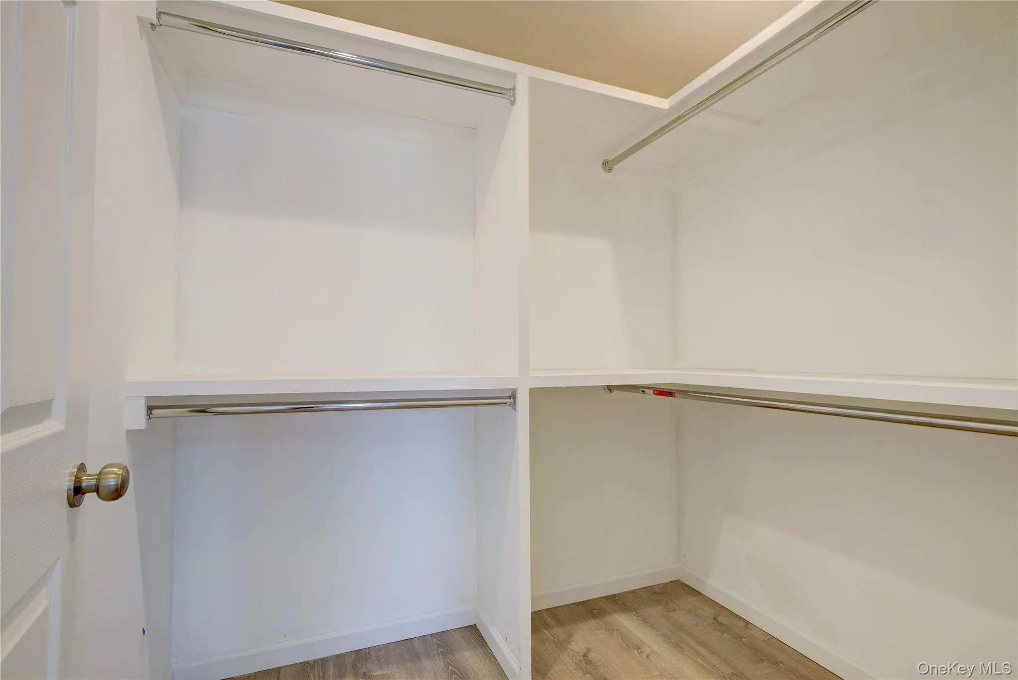 Spacious closet featuring light wood-type flooring Spacious closet featuring light wood-type flooring