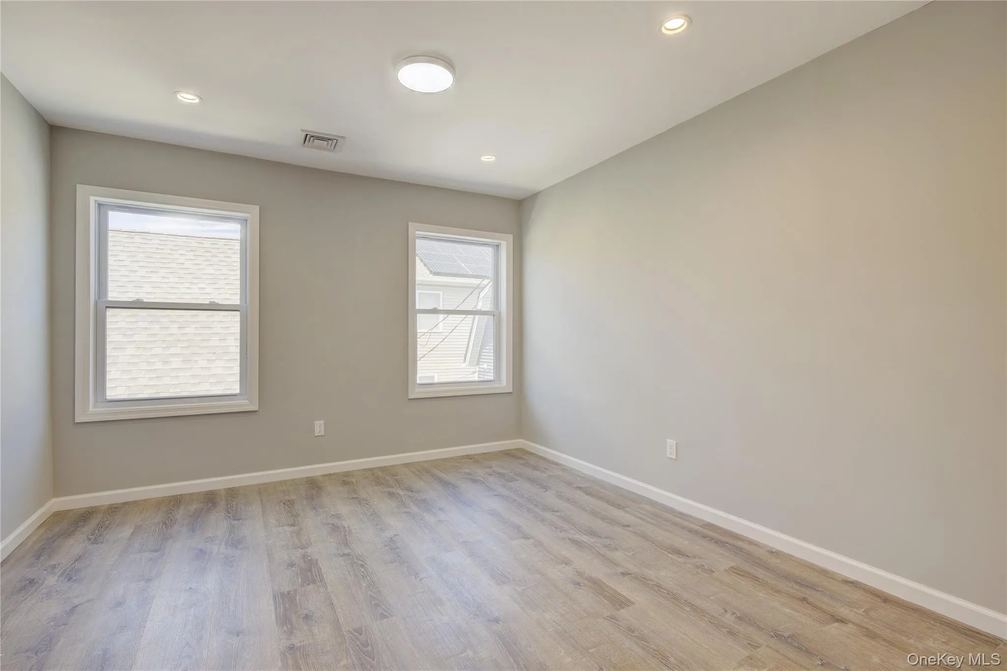 Spare room featuring plenty of natural light, light wood-type flooring, and recessed lighting Spare room featuring plenty of natural light, light wood-type flooring, and recessed lighting