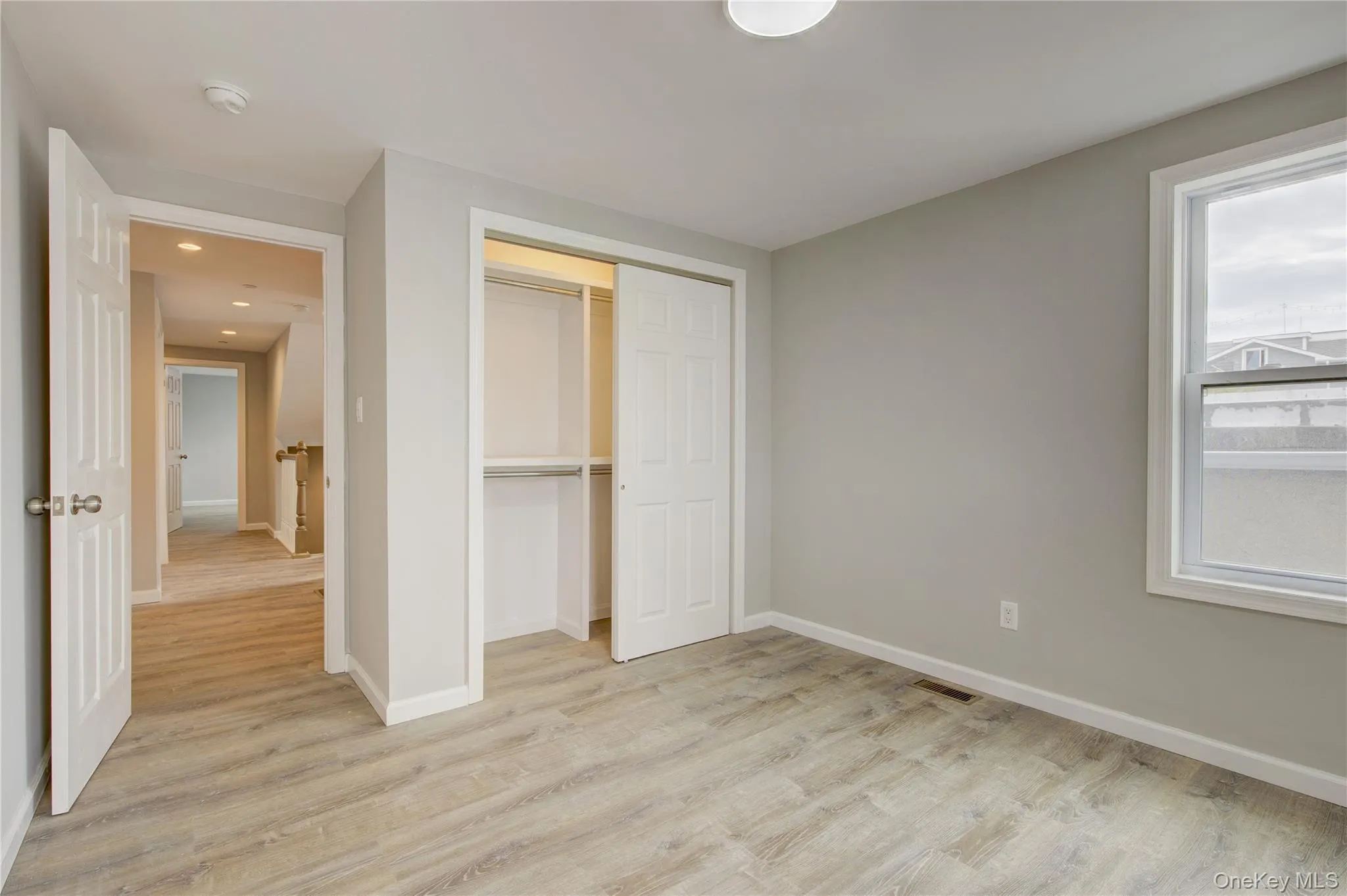Unfurnished bedroom with light wood-style floors and a closet Unfurnished bedroom with light wood-style floors and a closet